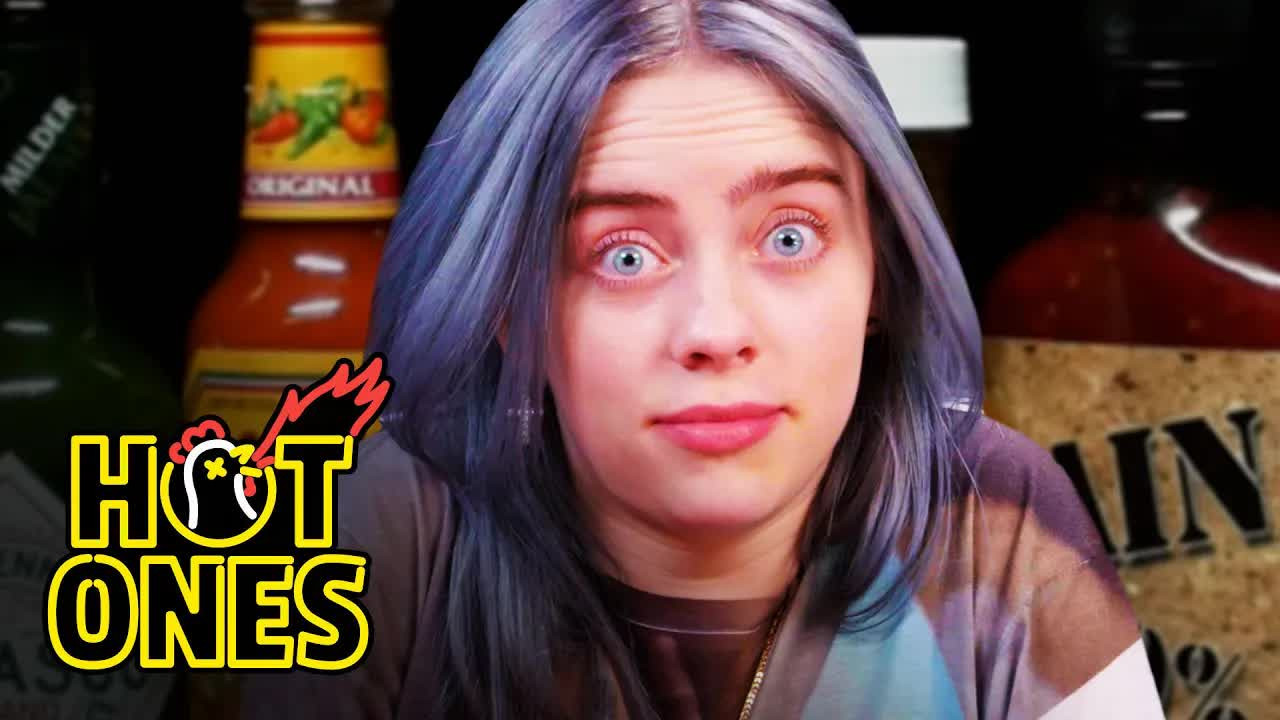 A still from Billie Eilish Freaks Out While Eating Spicy Wings