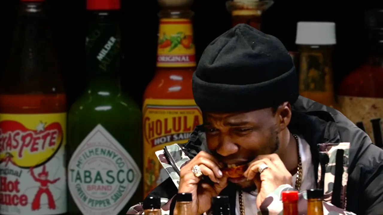 A still from Curren$y Talks Munchies, Industry Games, and Rap Dogs While Eating Spicy Wings
