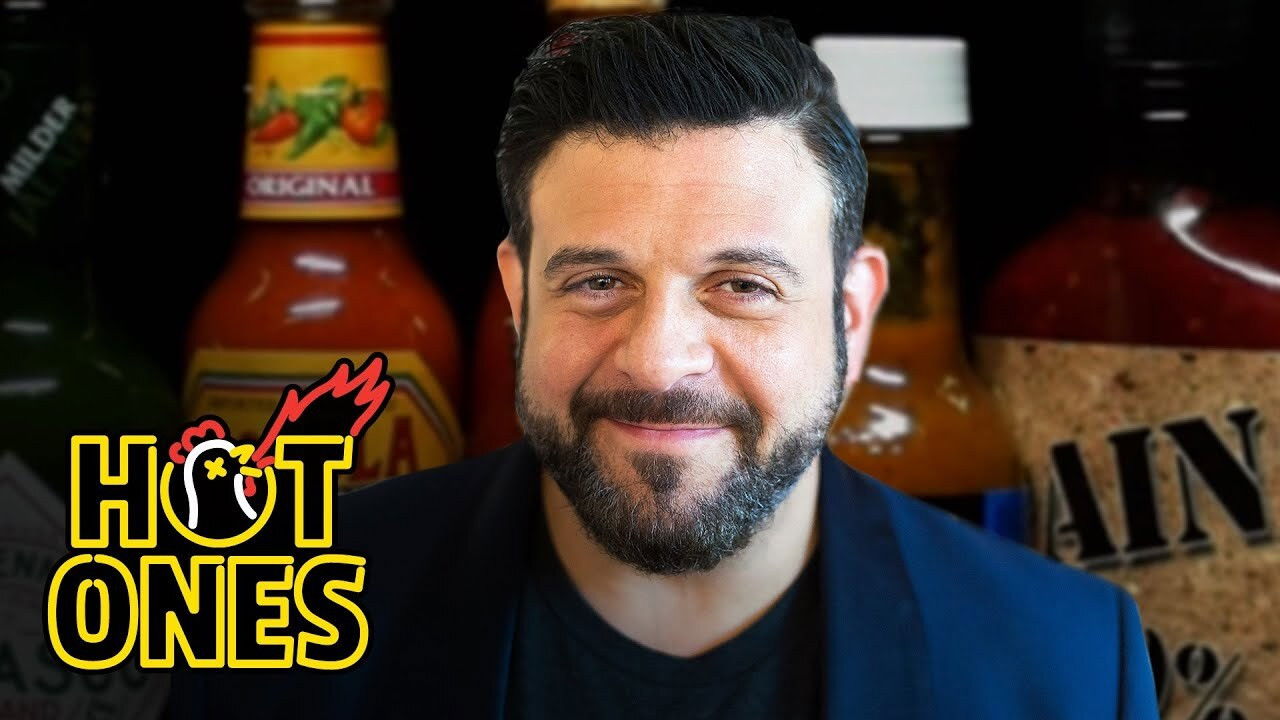 Adam Richman Impersonates Noel Gallagher While Eating Spicy Wings