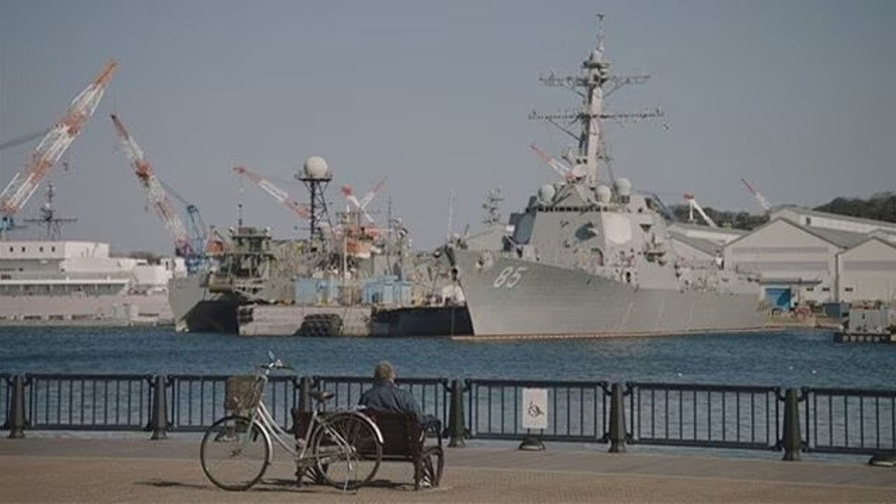 At a park in Yokosuka with a view of warships