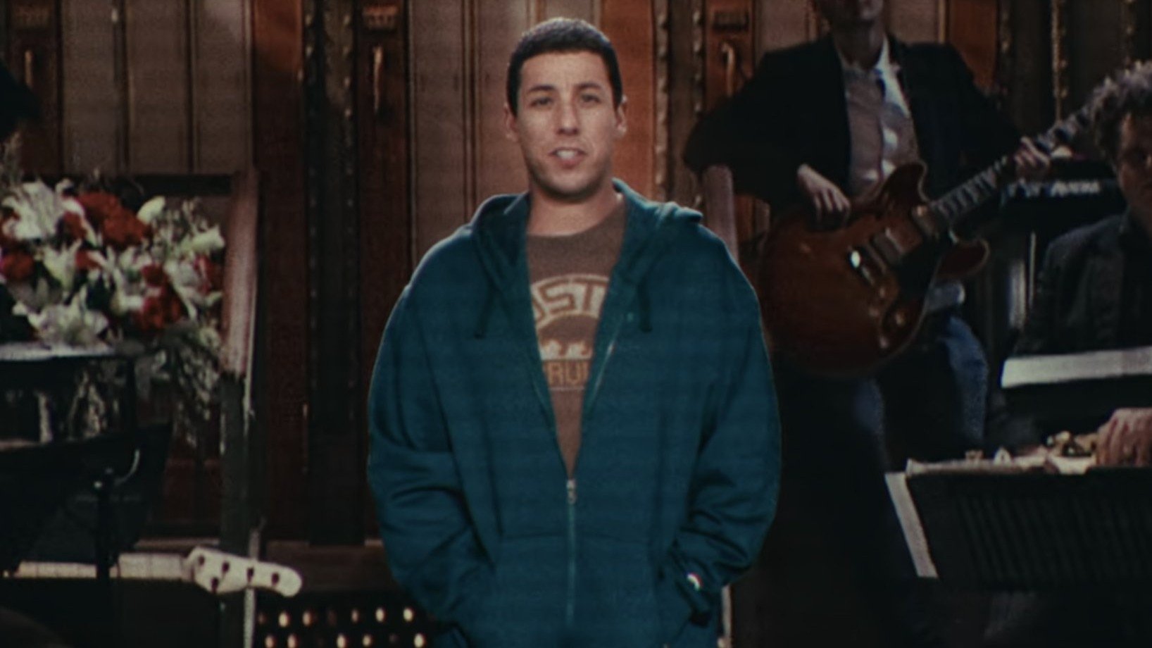 Caption: a man standing in front of a group of people
