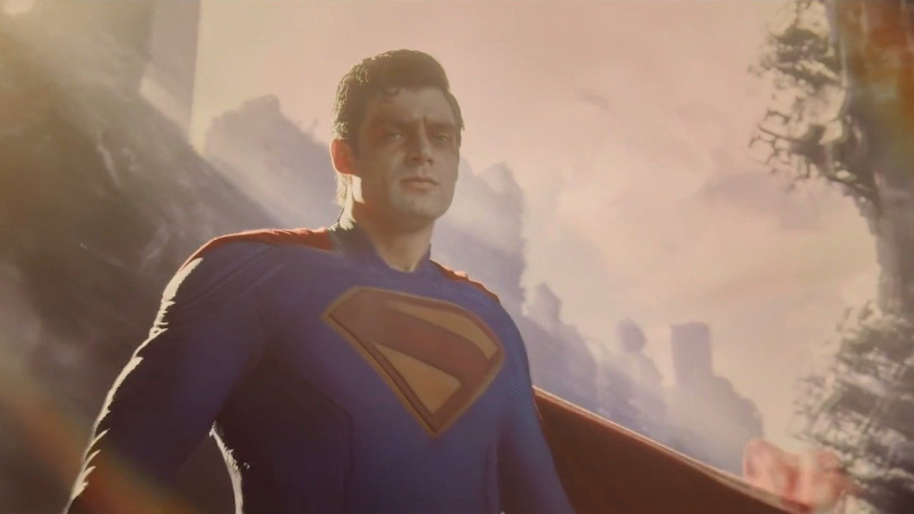 Caption: a man in a superman suit standing in front of a mountain