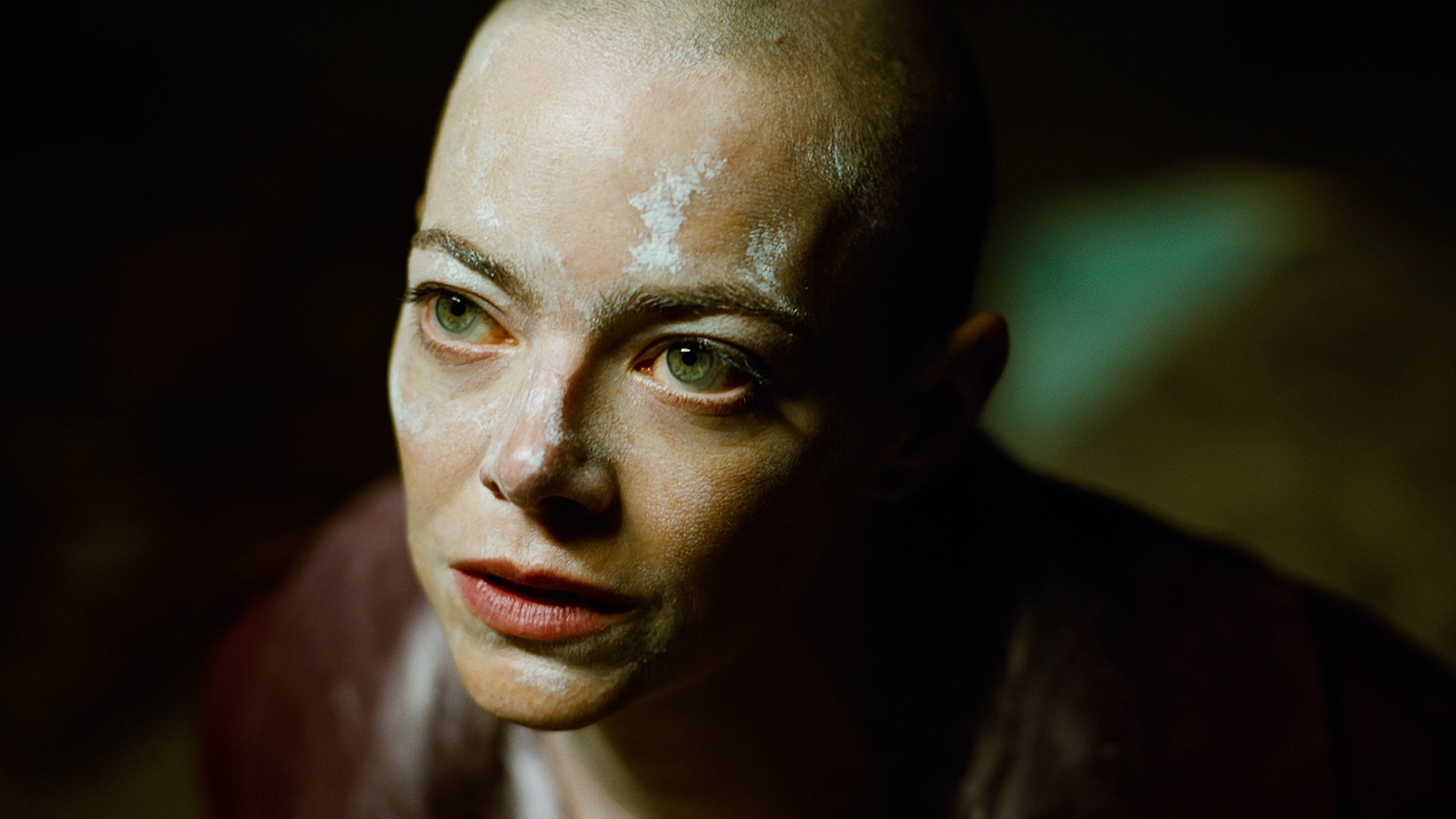 Caption: a woman with white paint on her face