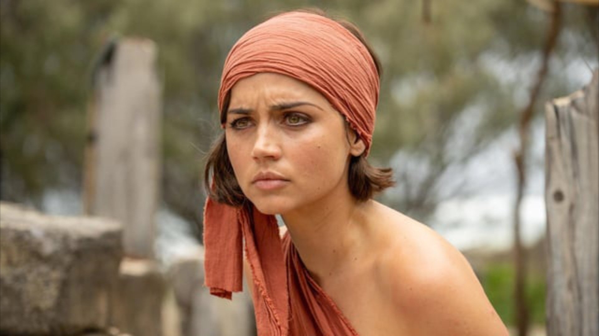 Caption: a woman wearing a red scarf around her head