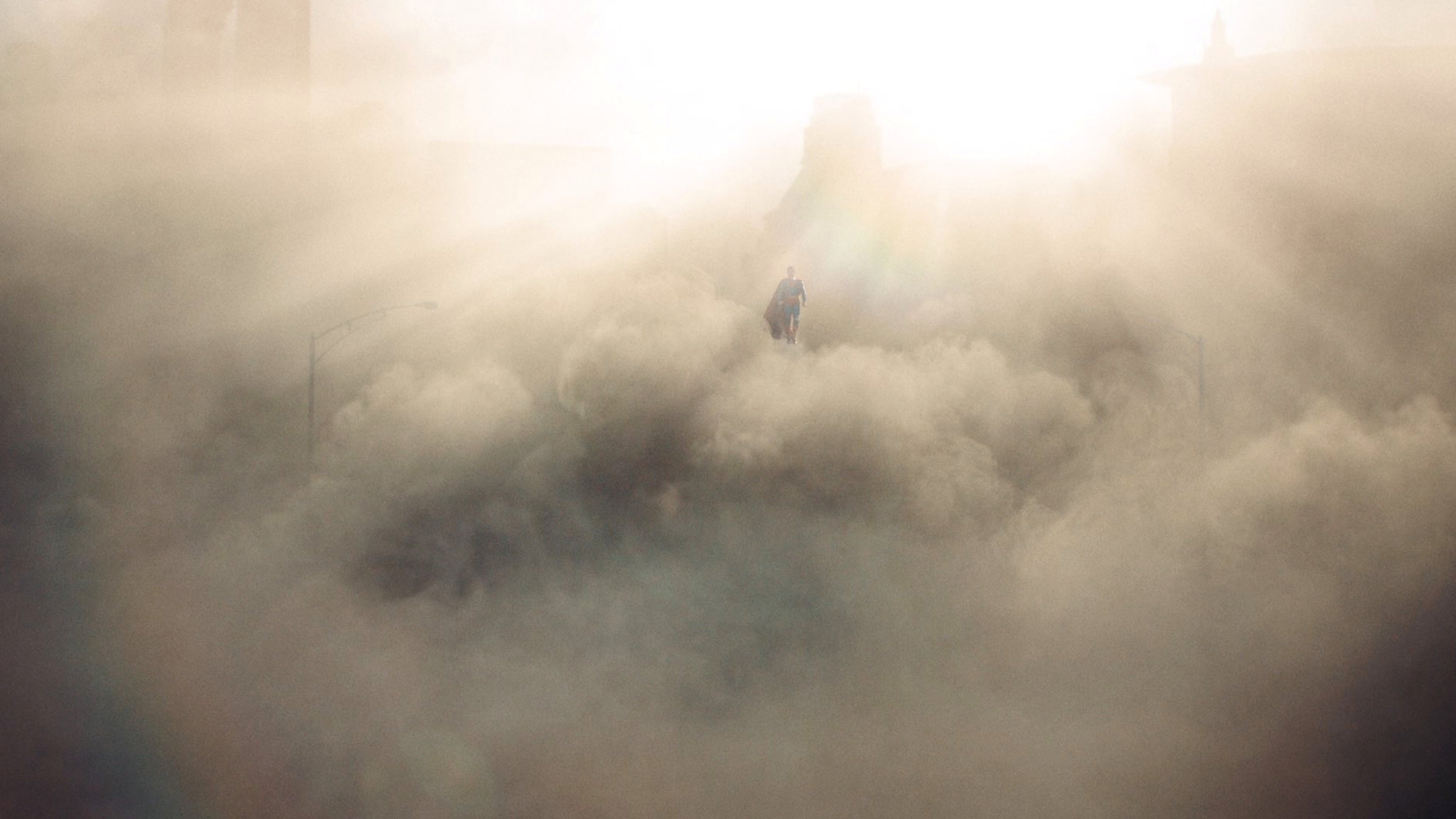 Caption: a person standing in the middle of a cloud of smoke