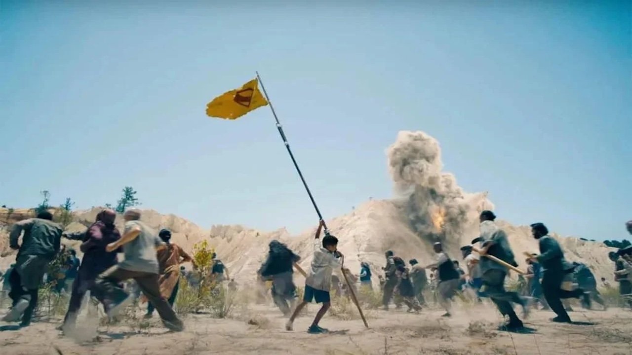 Caption: a group of people running across a dirt field