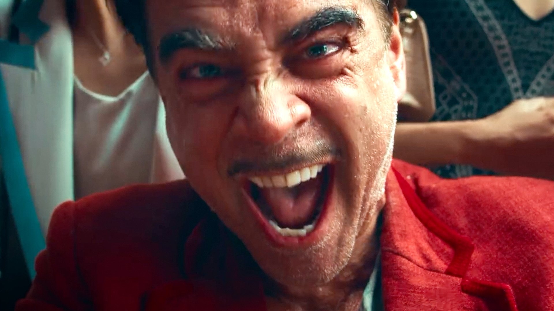 Caption: a man in a red jacket is making a face