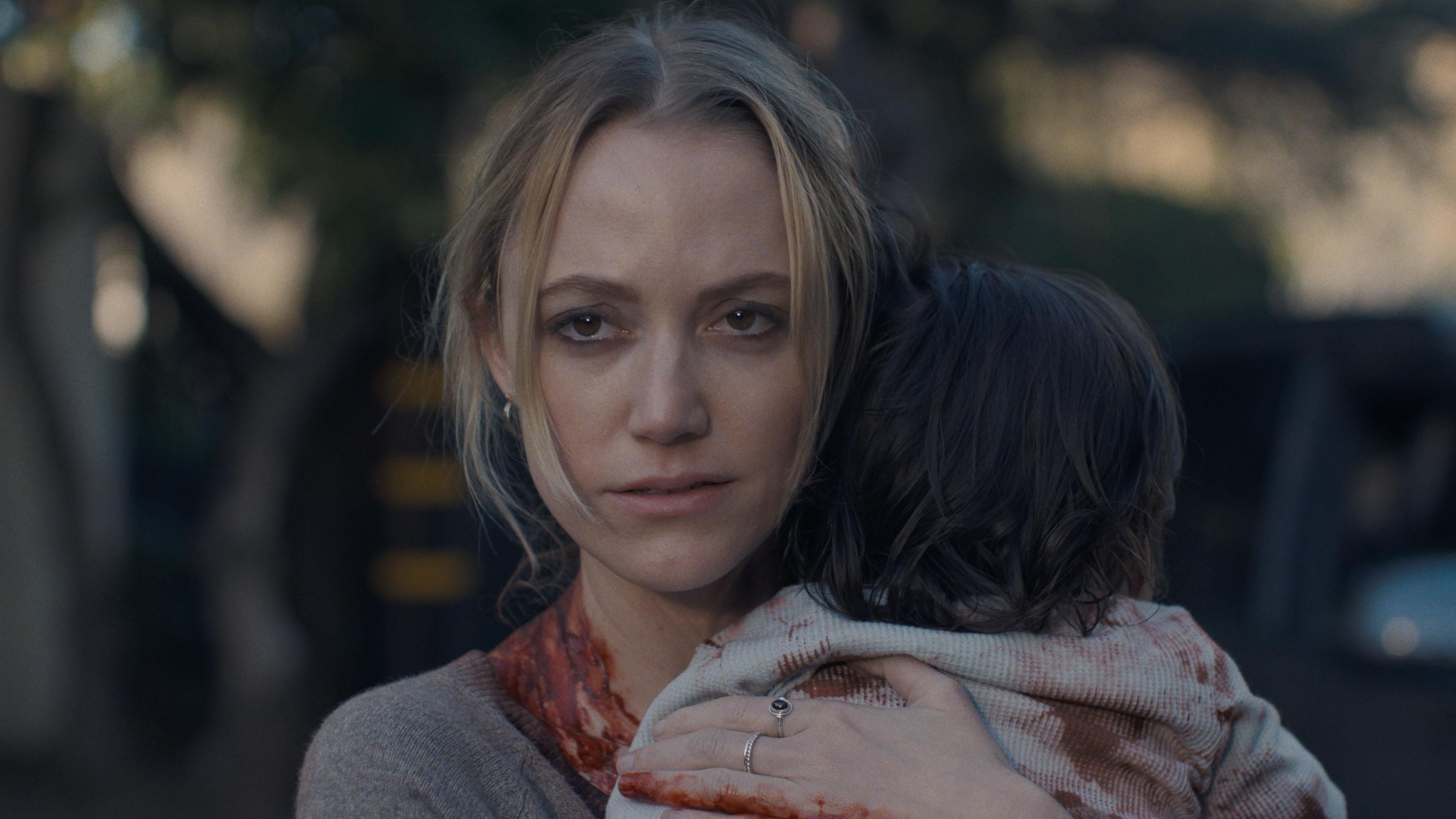 Caption: a woman holding a child in her arms