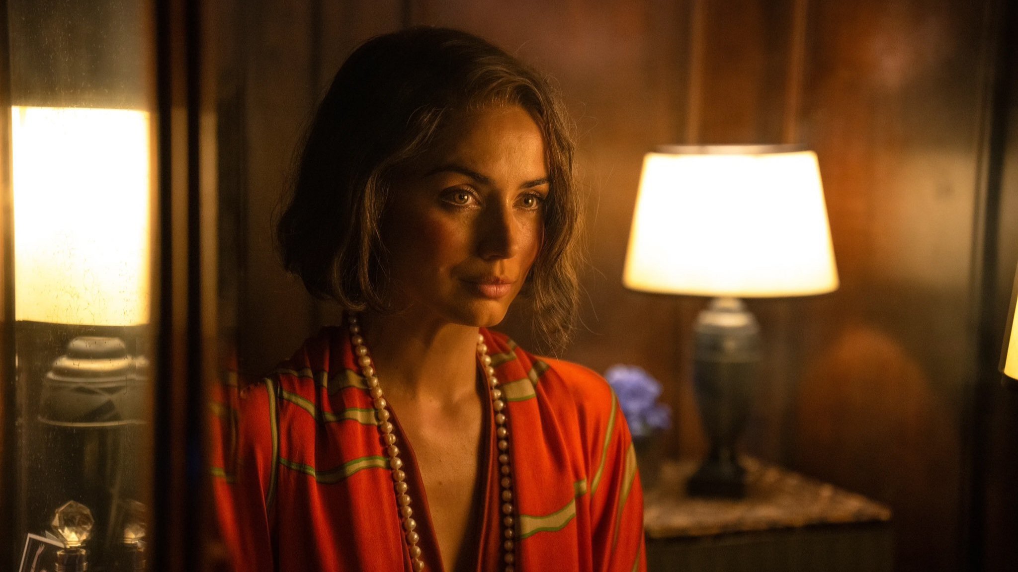 Caption: a woman standing in a room next to a lamp