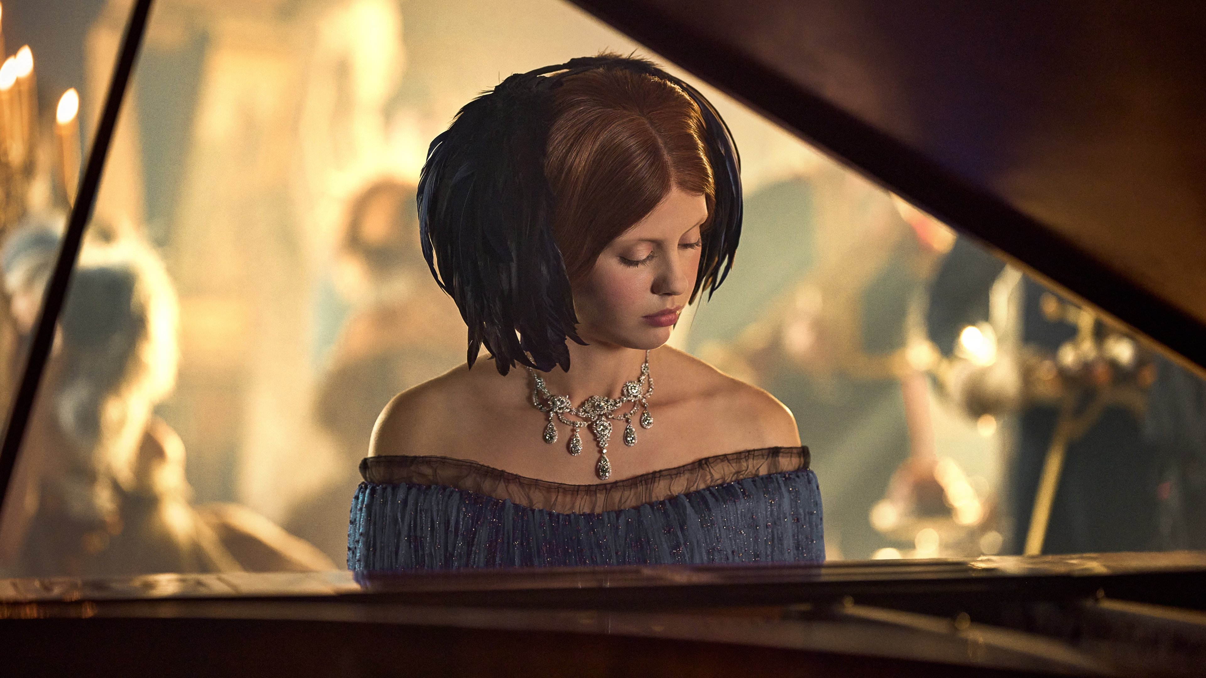 Caption: a woman in a blue dress playing a piano