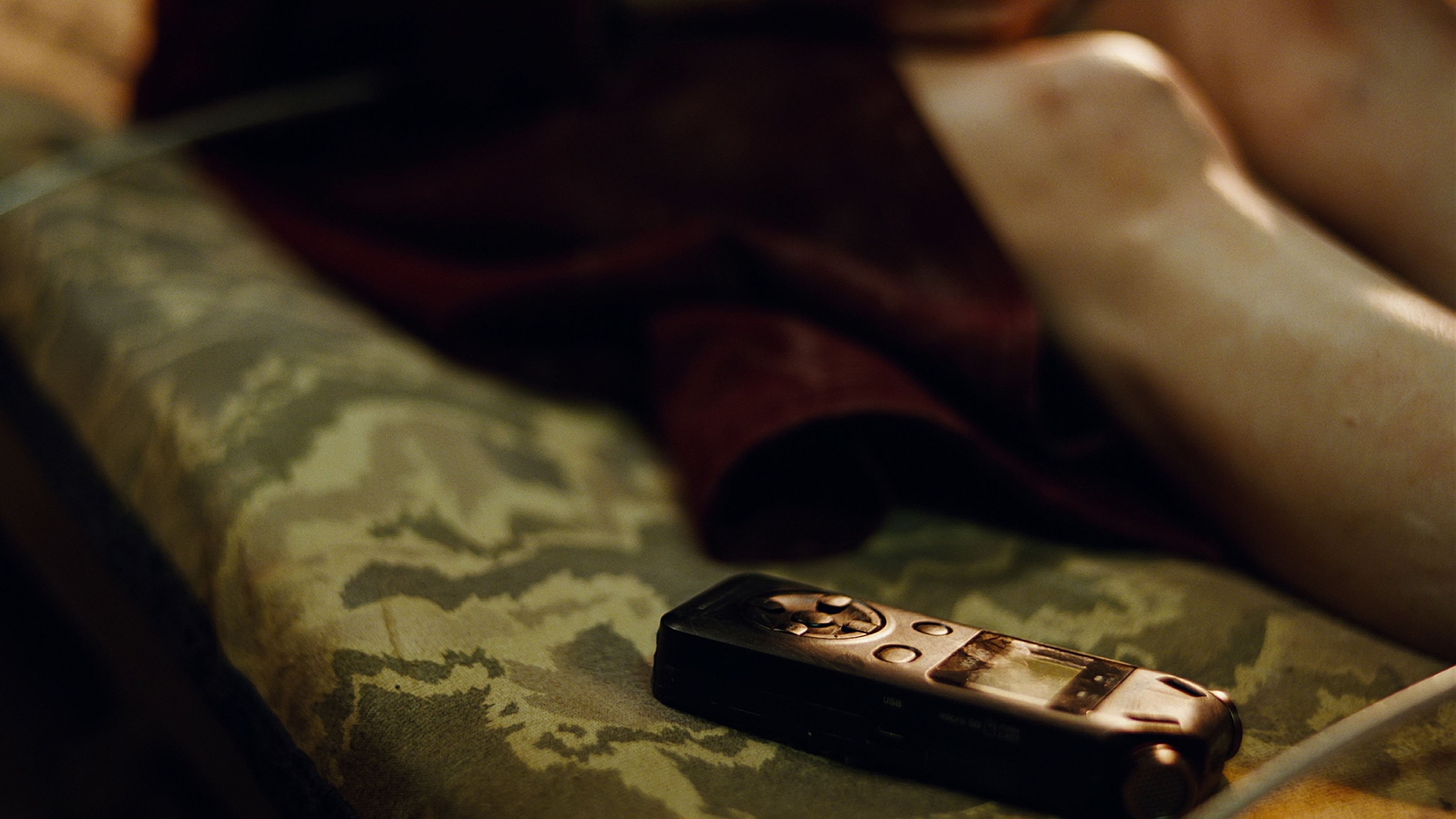 Caption: a close up of a remote control on a couch