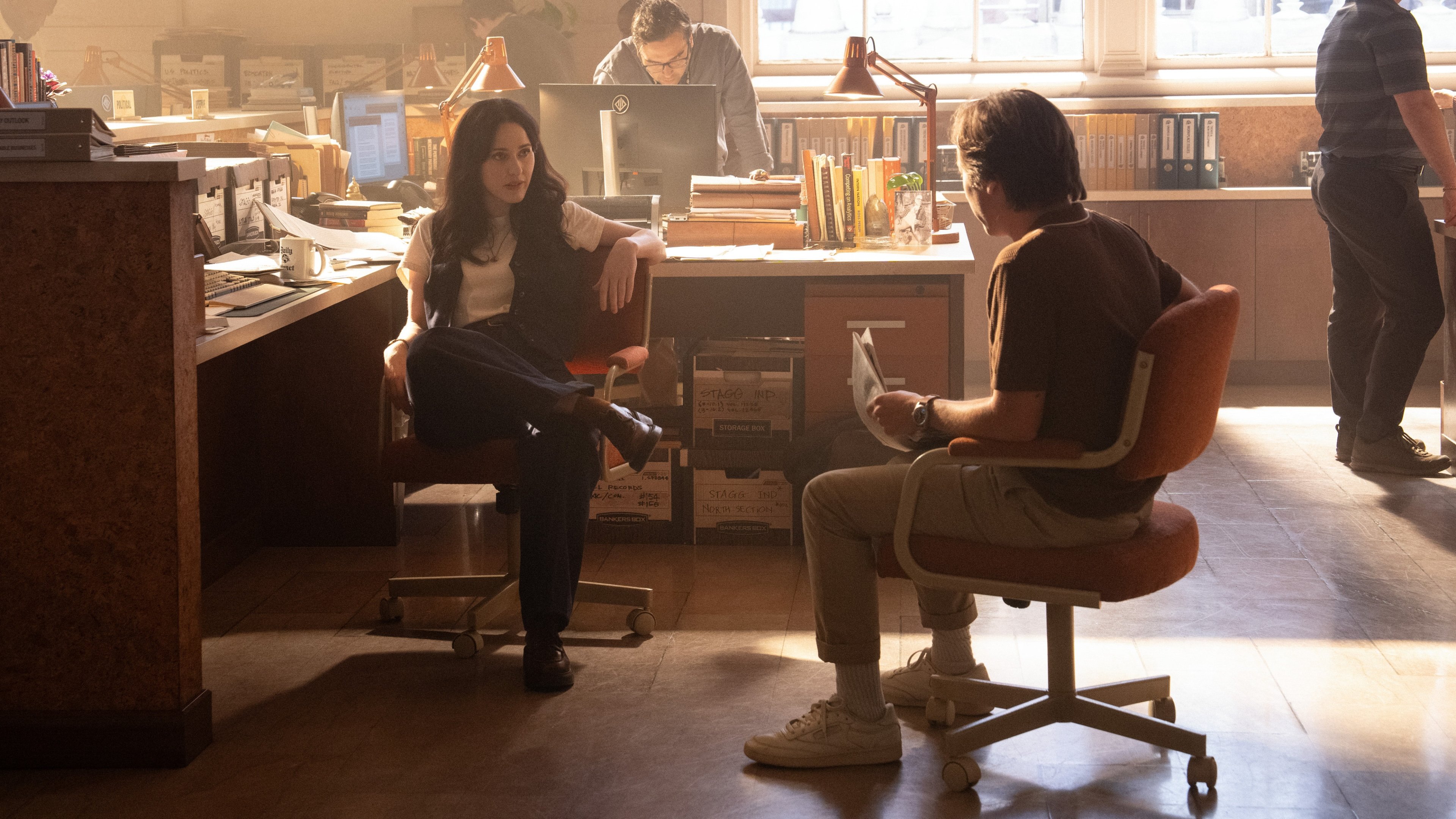 Caption: a man and a woman sitting at a desk
