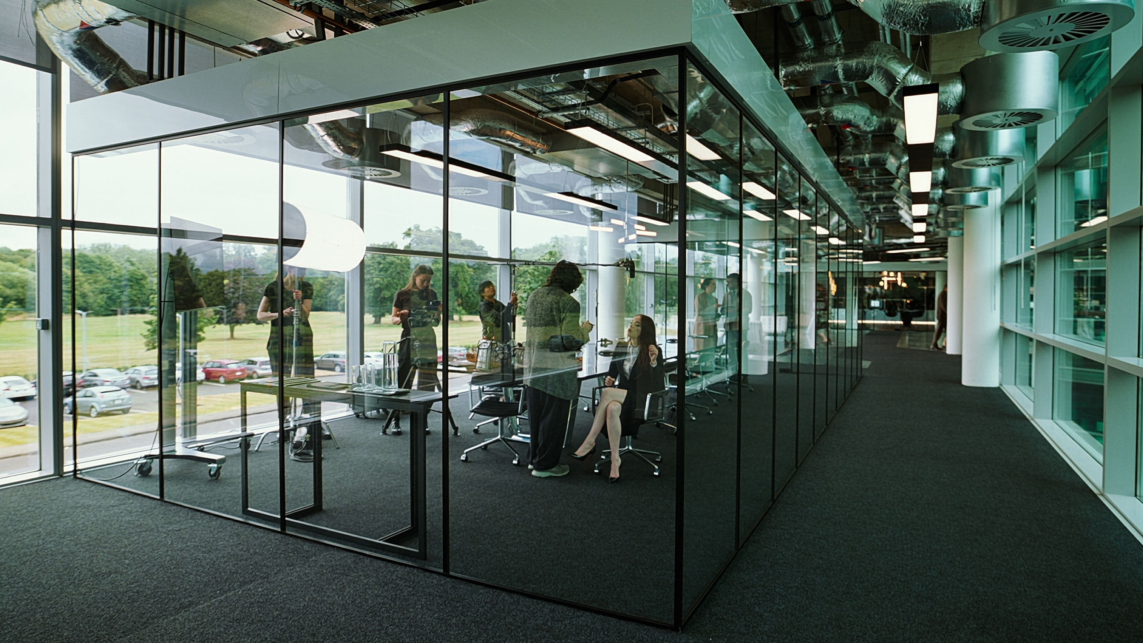 Caption: a group of people sitting at a table in an office