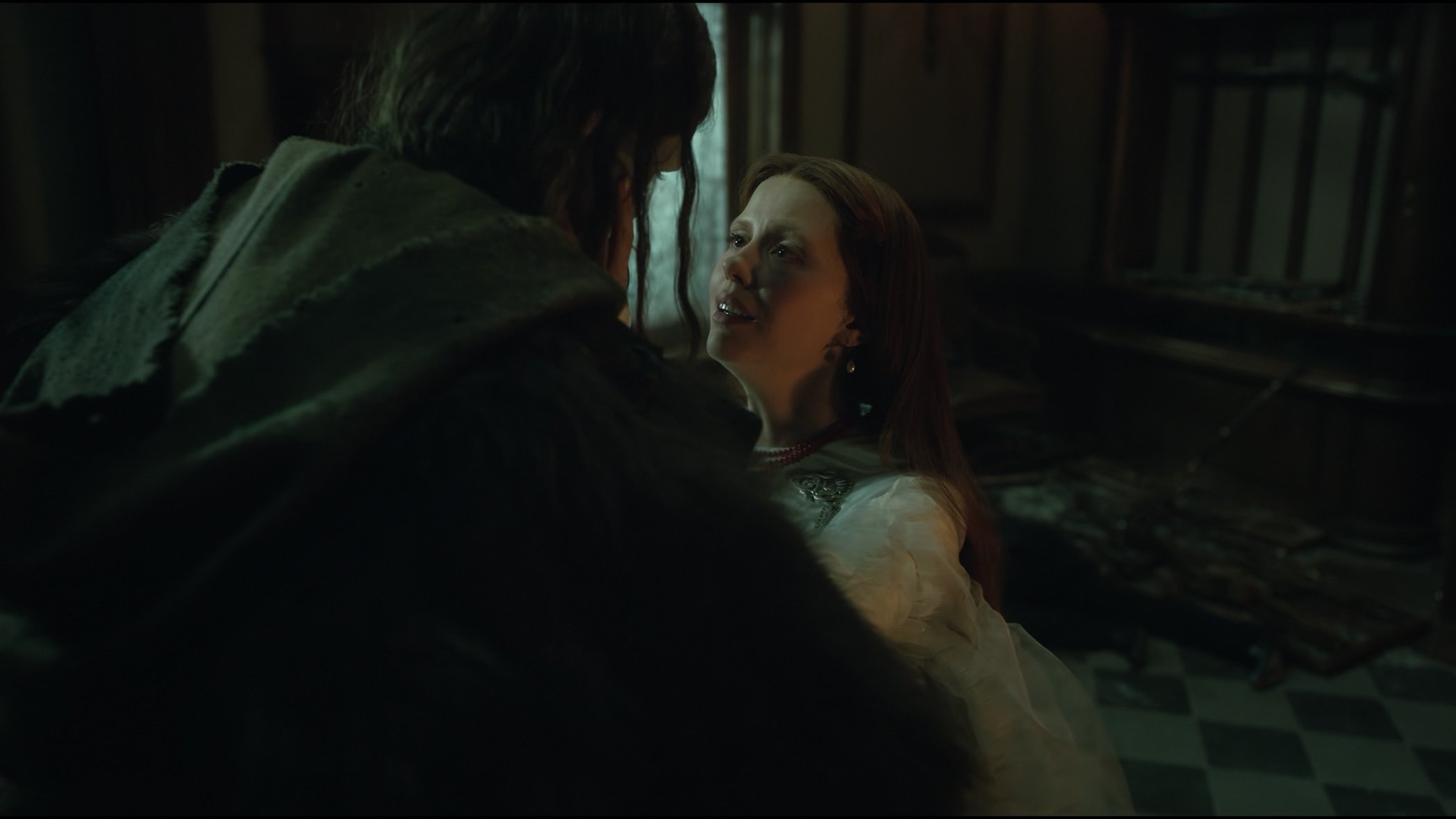 Caption: a woman standing next to a man in a room