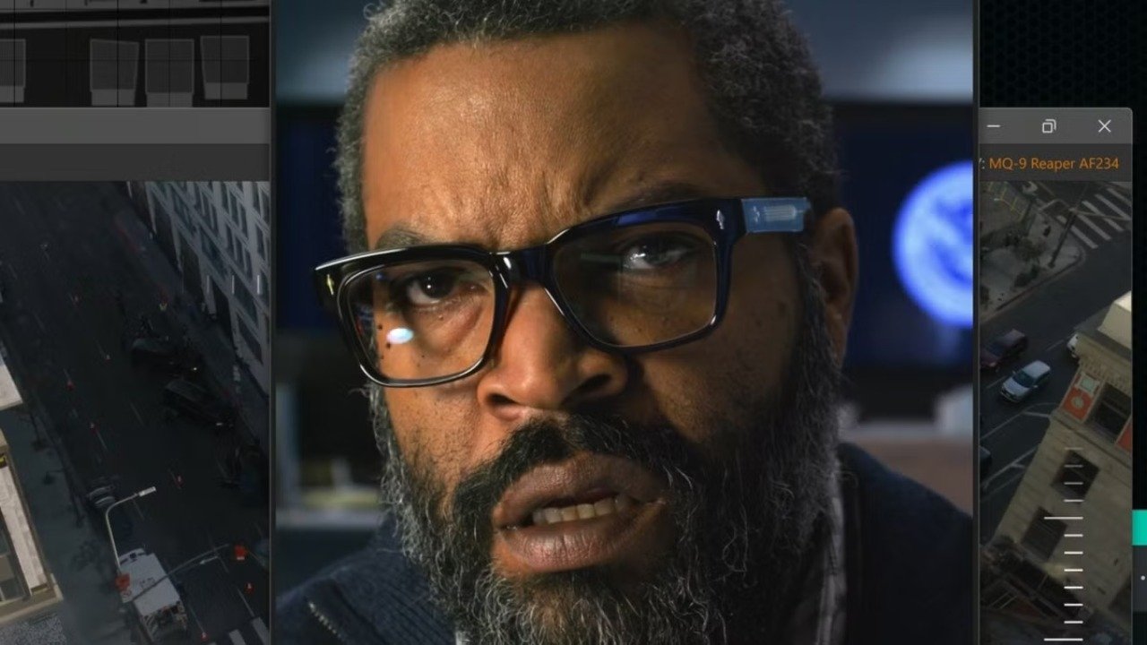 Caption: a man with glasses and a beard is looking at the camera