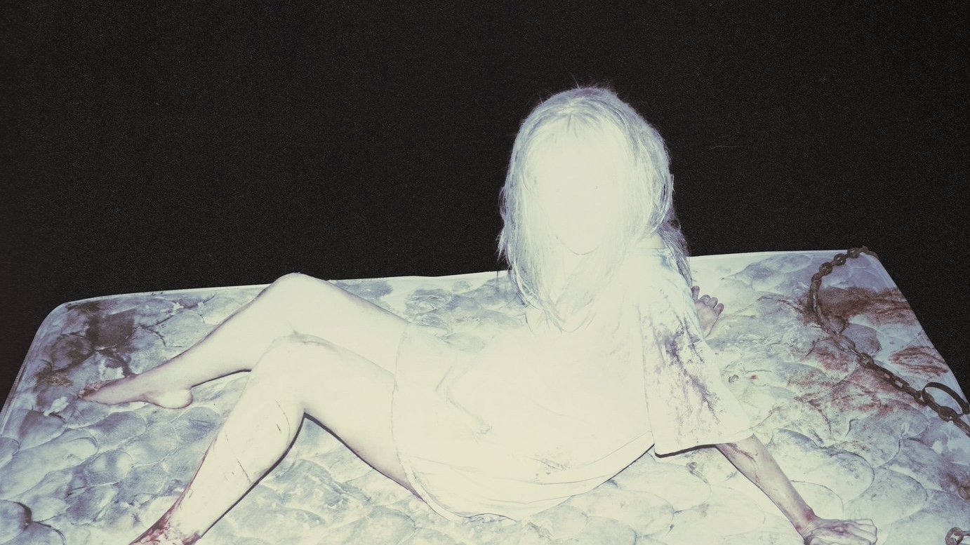 Caption: a woman laying on top of a bed covered in ice