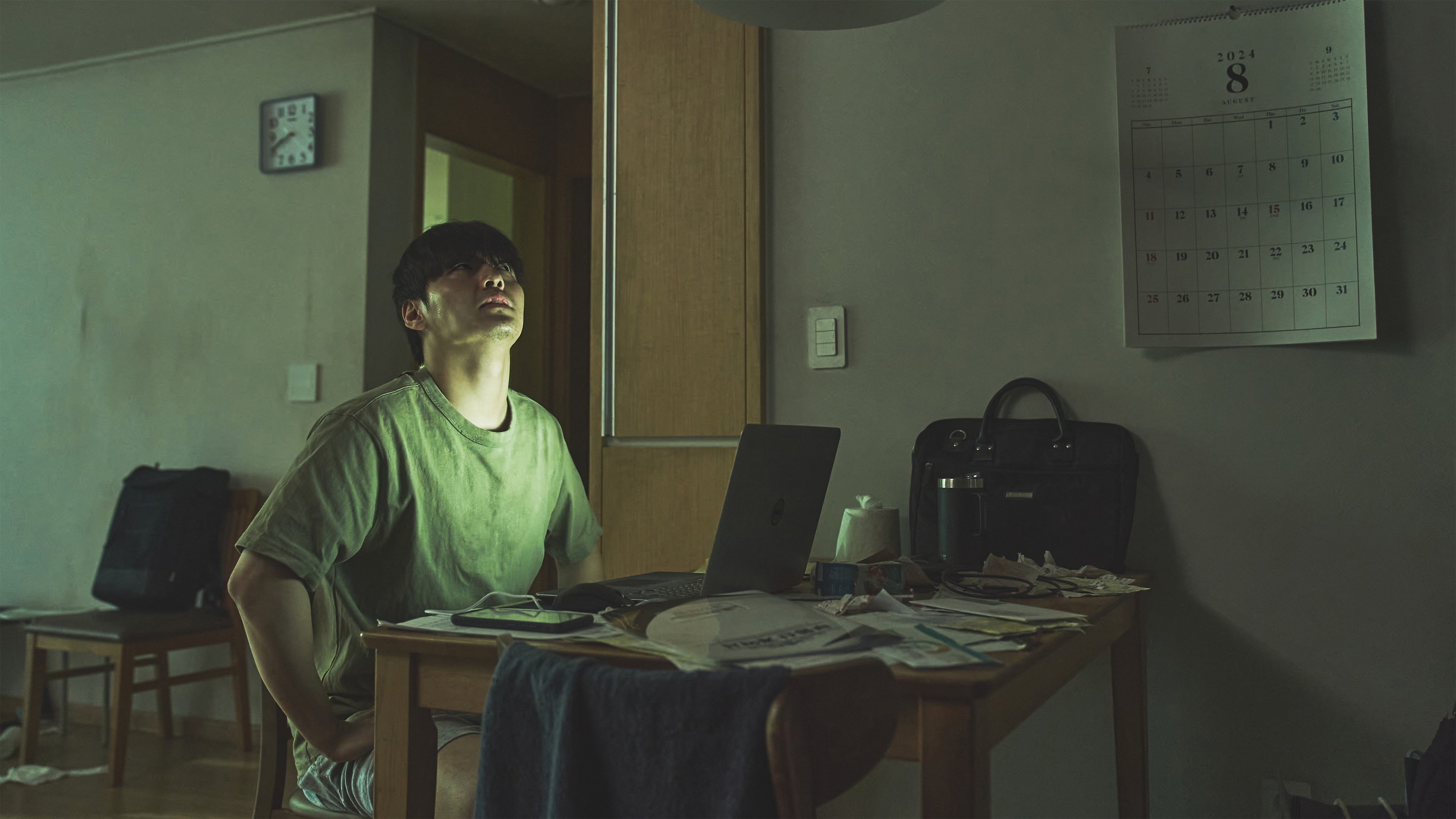Caption: a man sitting in front of a laptop computer