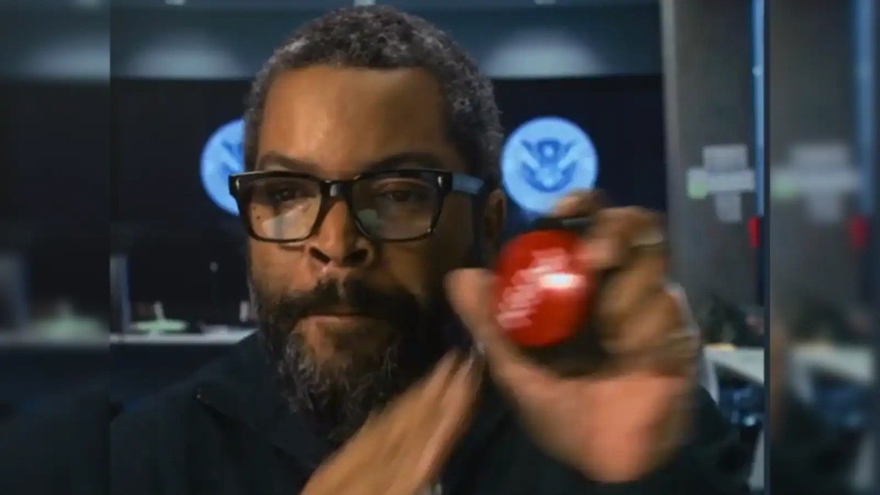 Caption: a man holding a red apple in his right hand