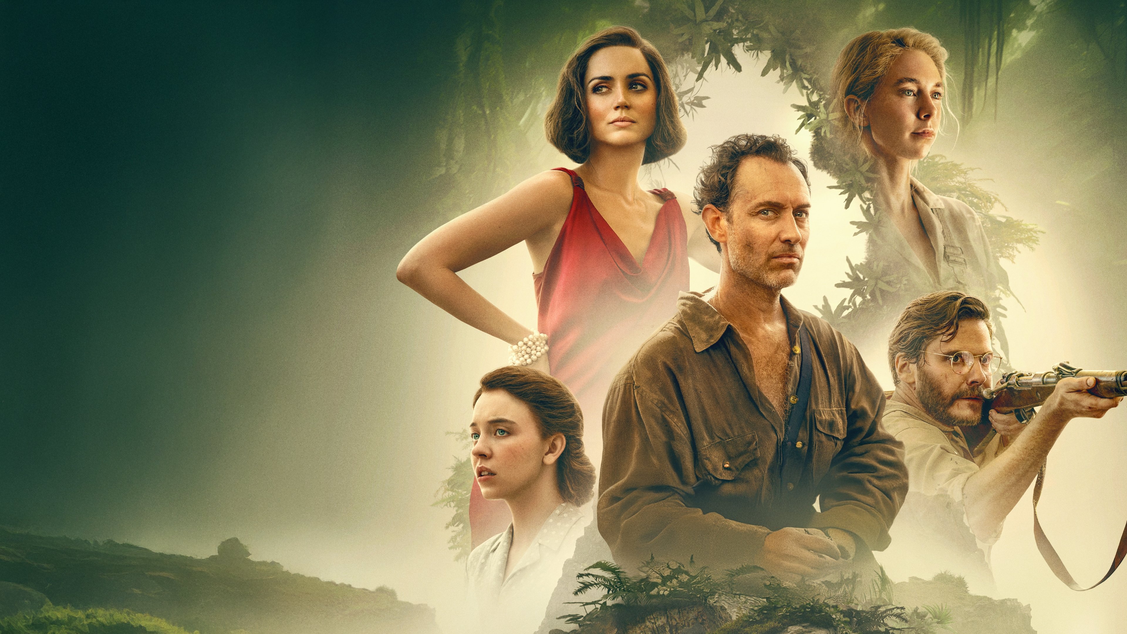 Caption: a group of people standing in front of a jungle