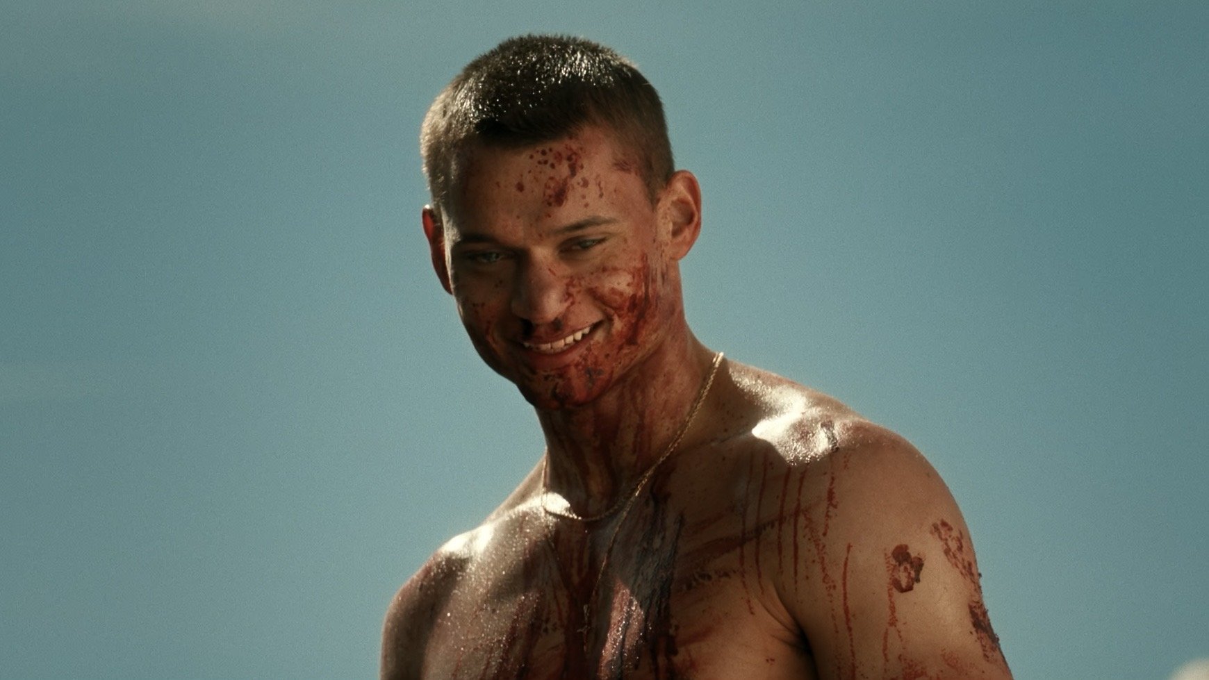 Caption: a shirtless man with blood all over his face