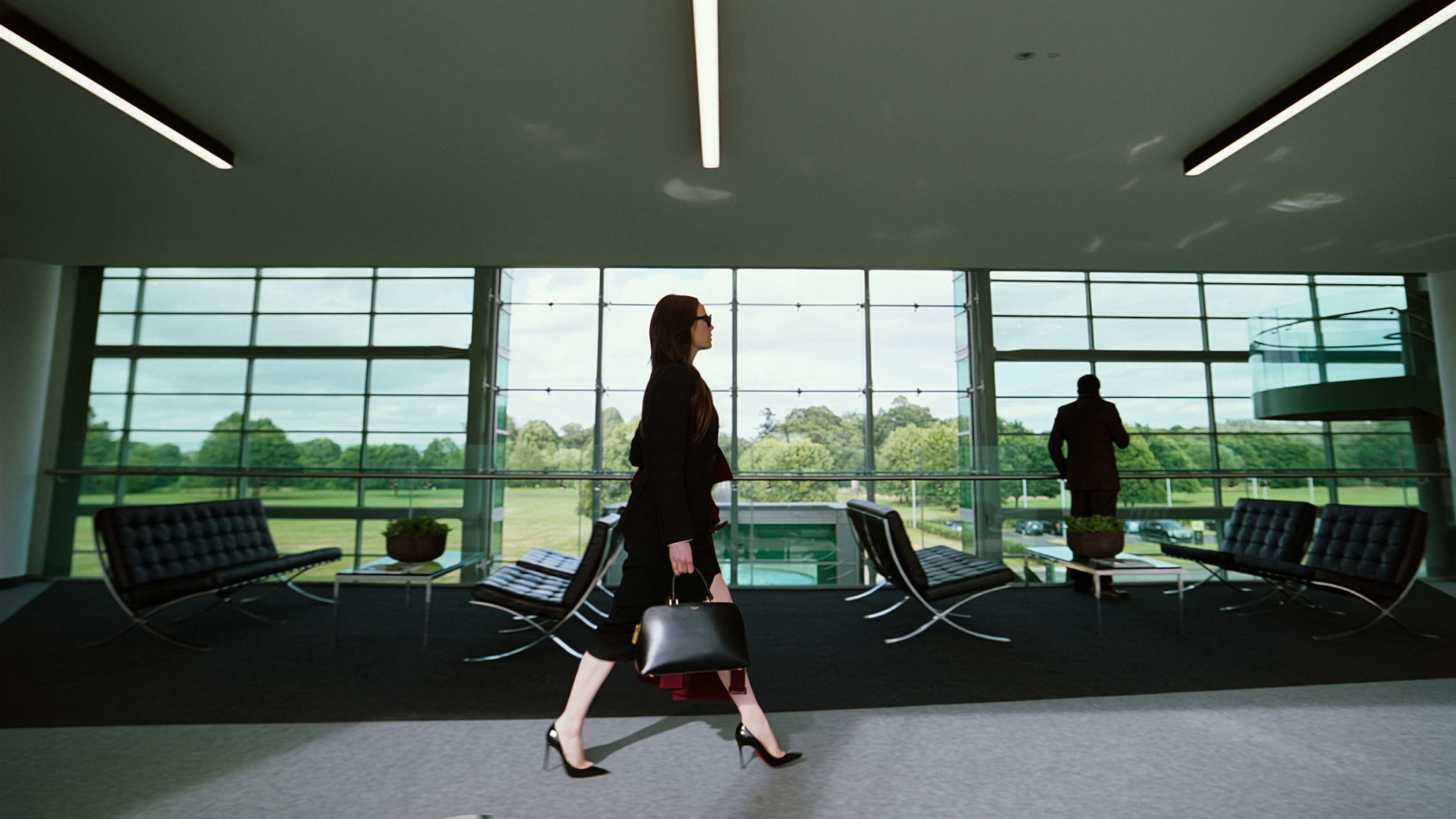 Caption: a woman walking through an airport with luggage