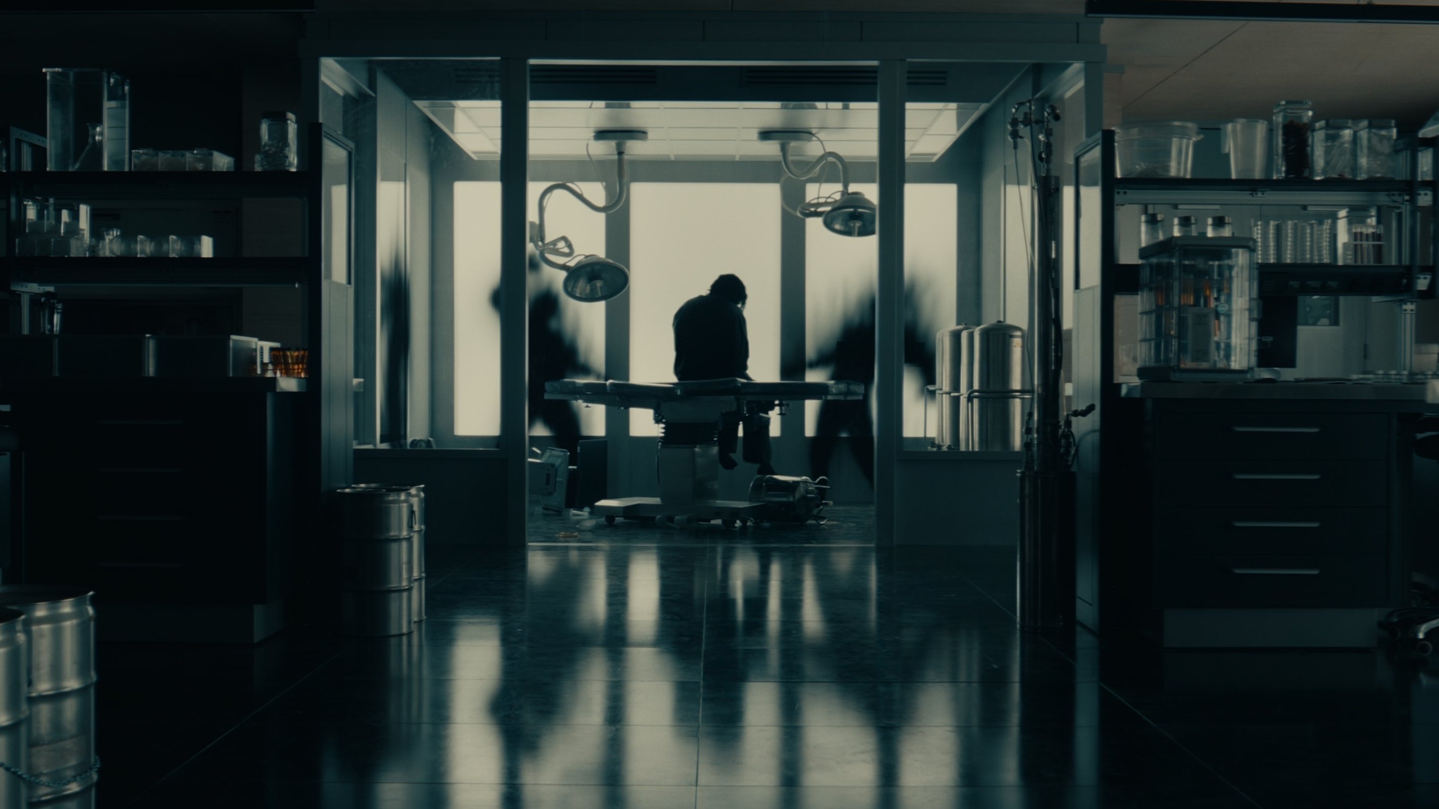 Caption: a person sitting at a table in a dark room