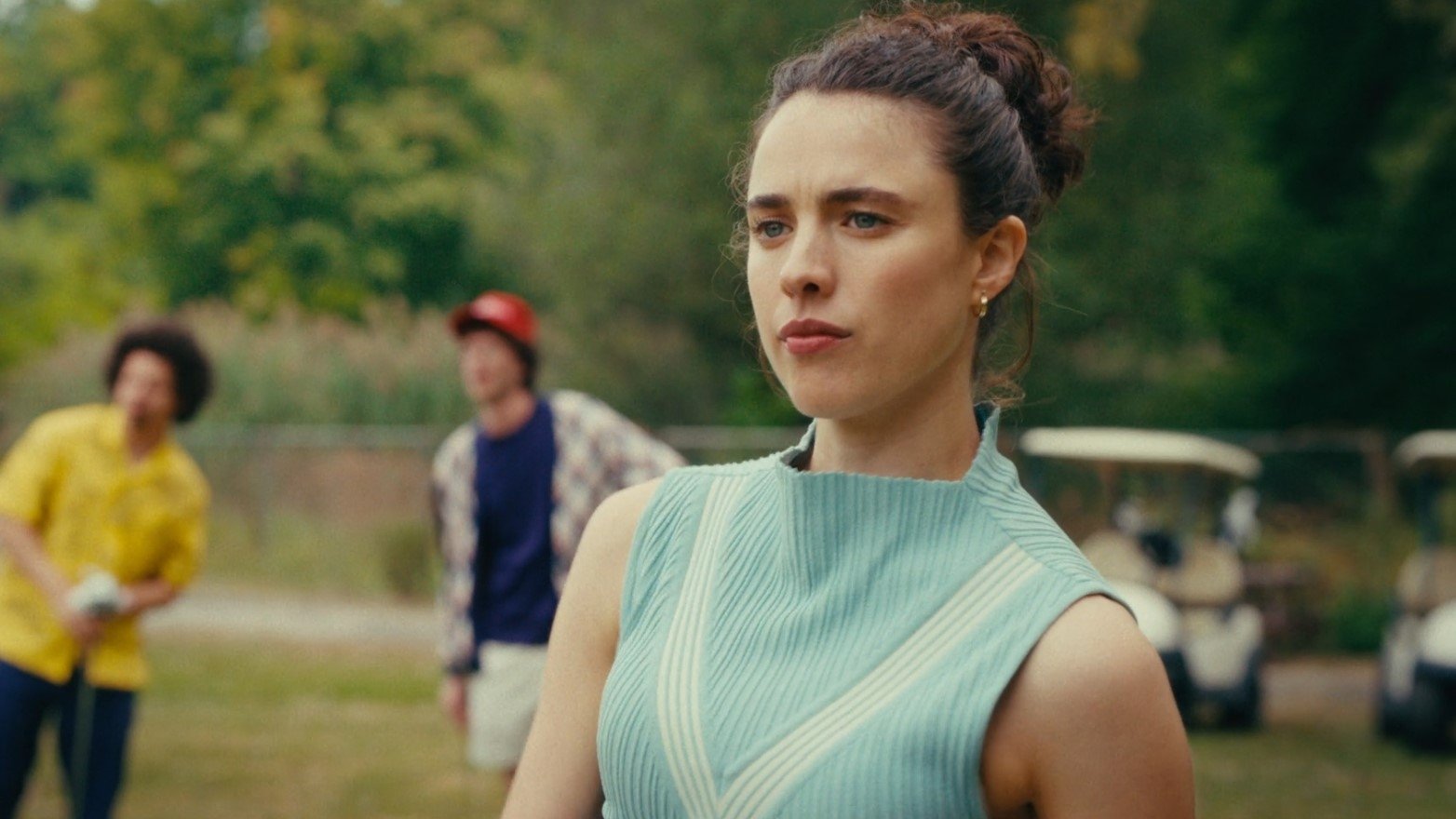 Caption: a woman in a blue dress standing next to a man in a yellow shirt