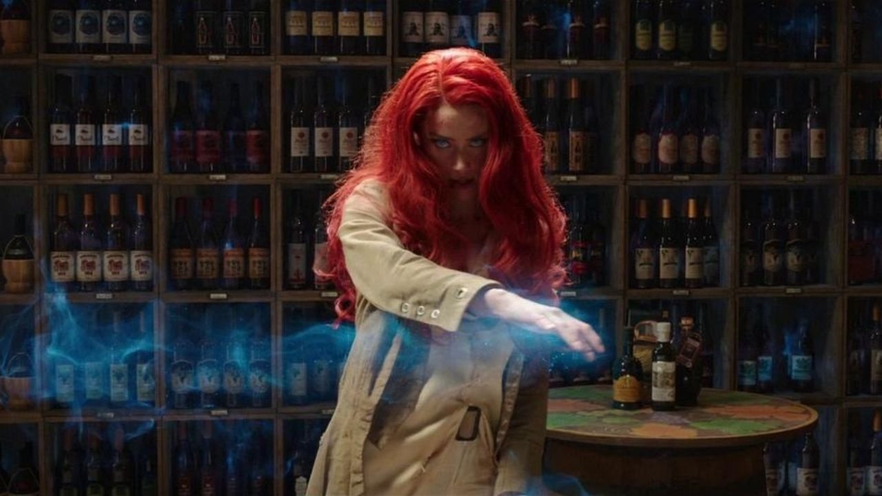 Caption: a woman with long red hair standing in front of a shelf of bottles