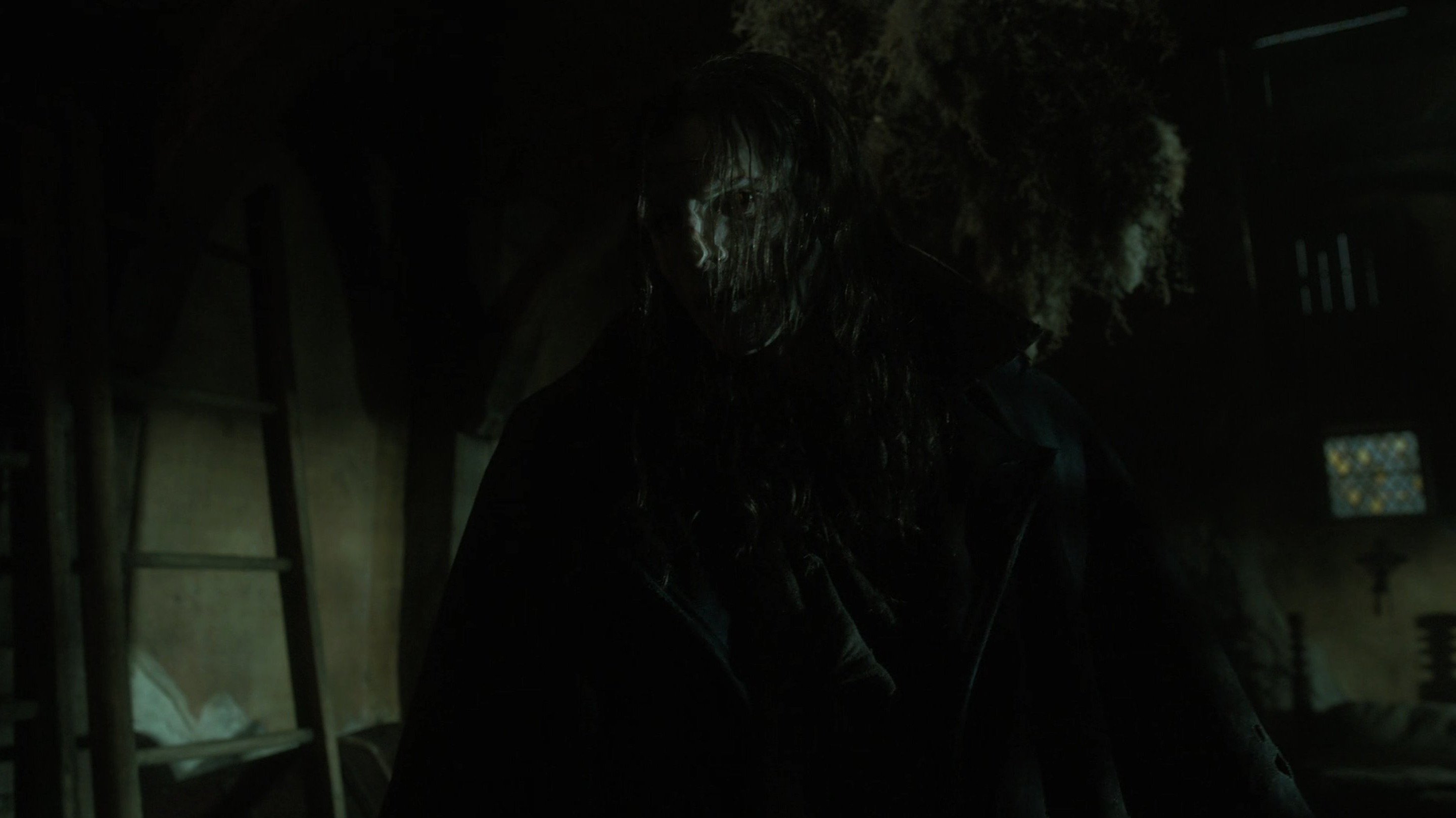 Caption: a man in a dark room with long hair