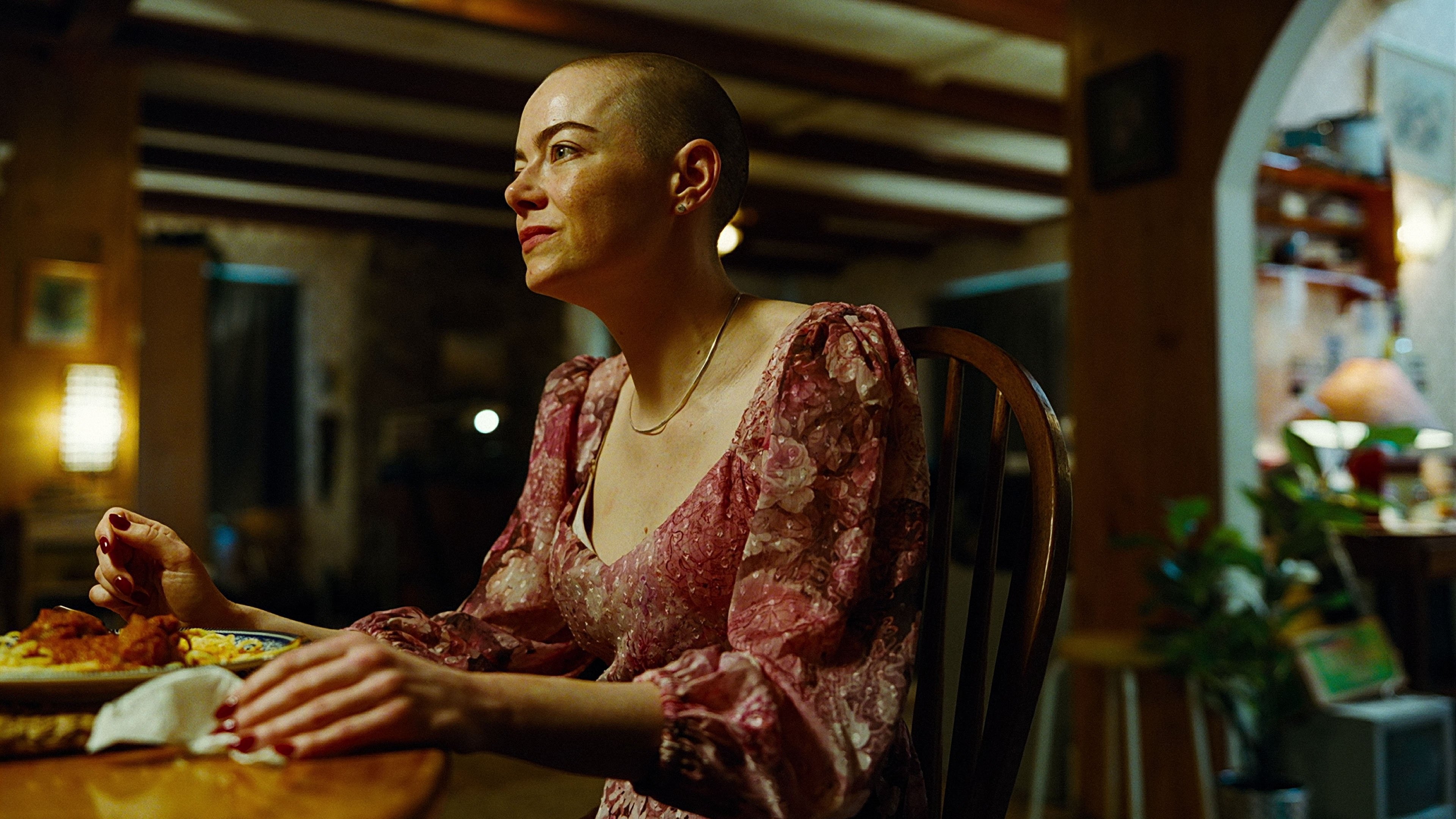 Caption: a woman sitting at a table with a plate of food