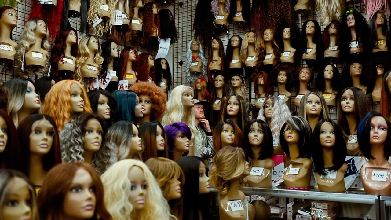 Caption: a bunch of wigs that are on display