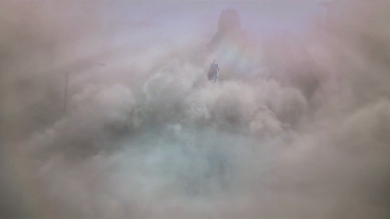 Caption: a bird flying through a cloud filled sky