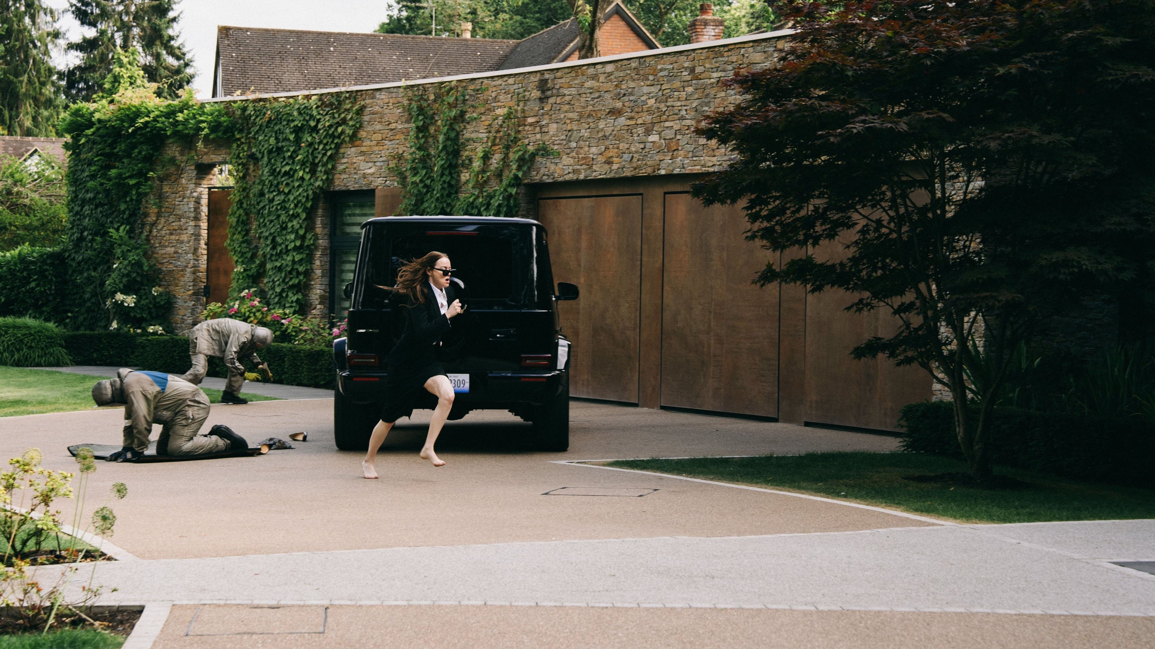 Caption: a woman in a business suit running towards a van