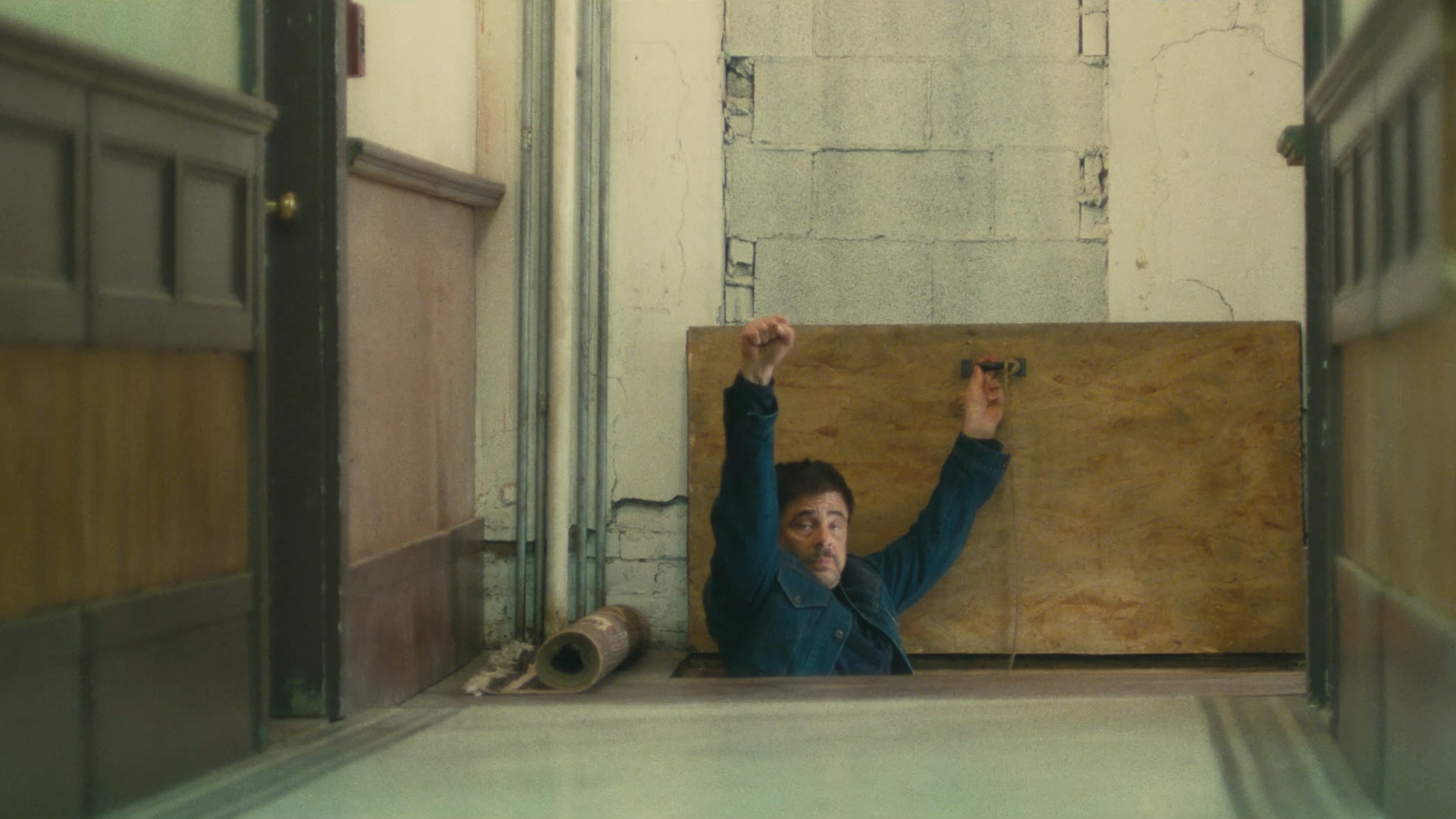 Caption: a man laying on the floor with his arms up