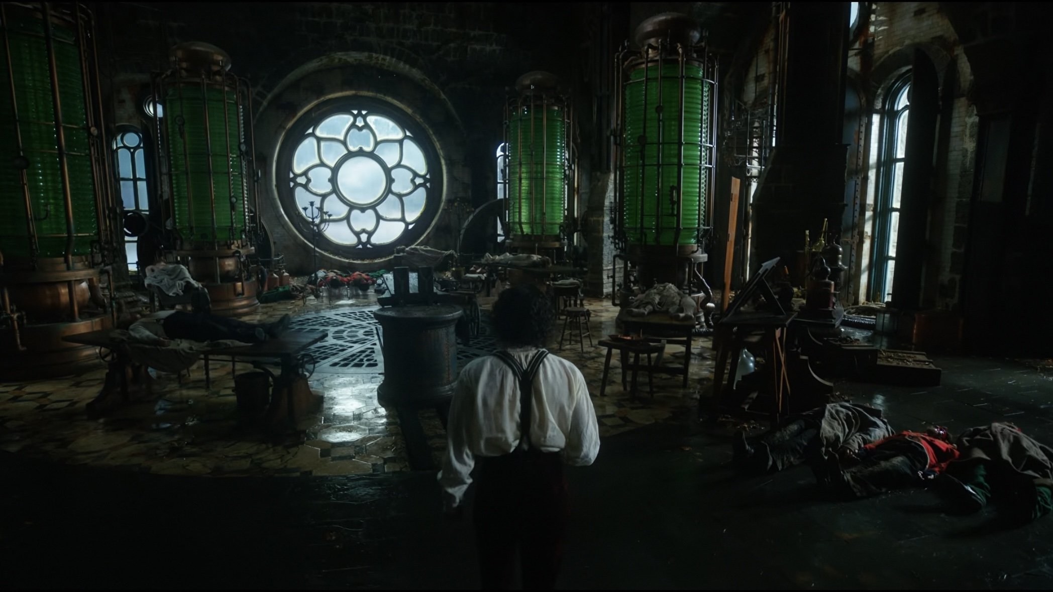 Caption: a man standing in front of a large window in a dark room