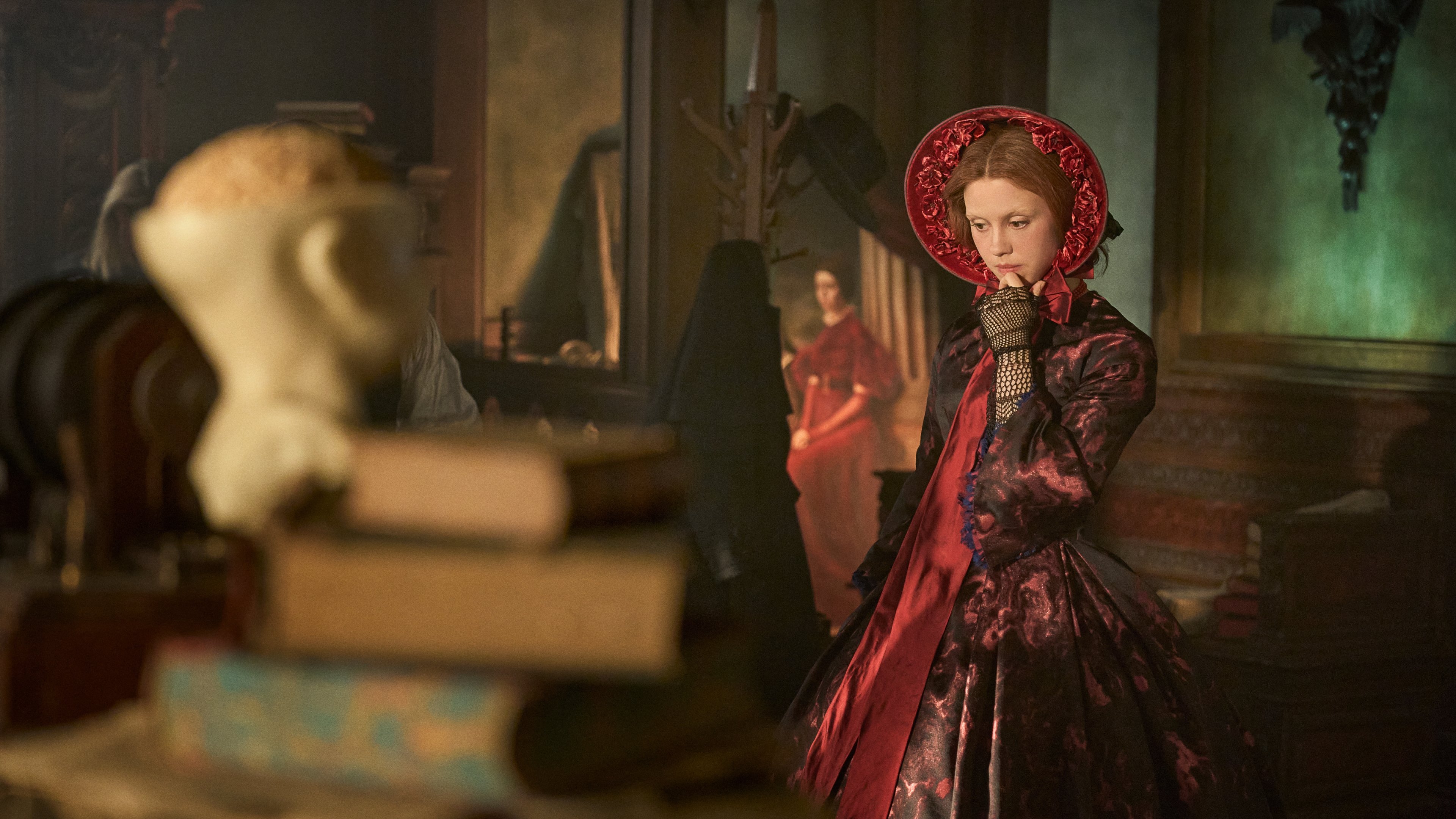 Caption: a woman in a red dress and a red hat