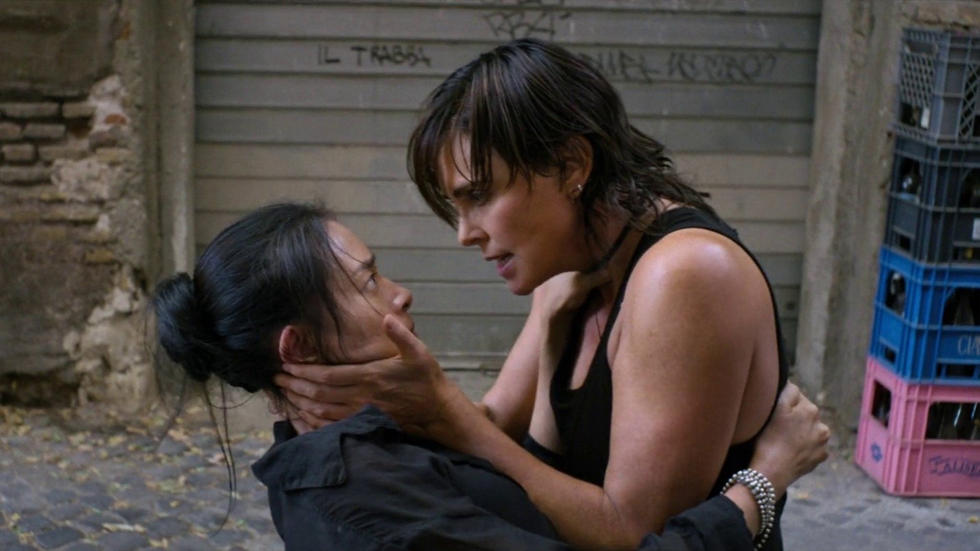Caption: a woman hugging another woman on the street