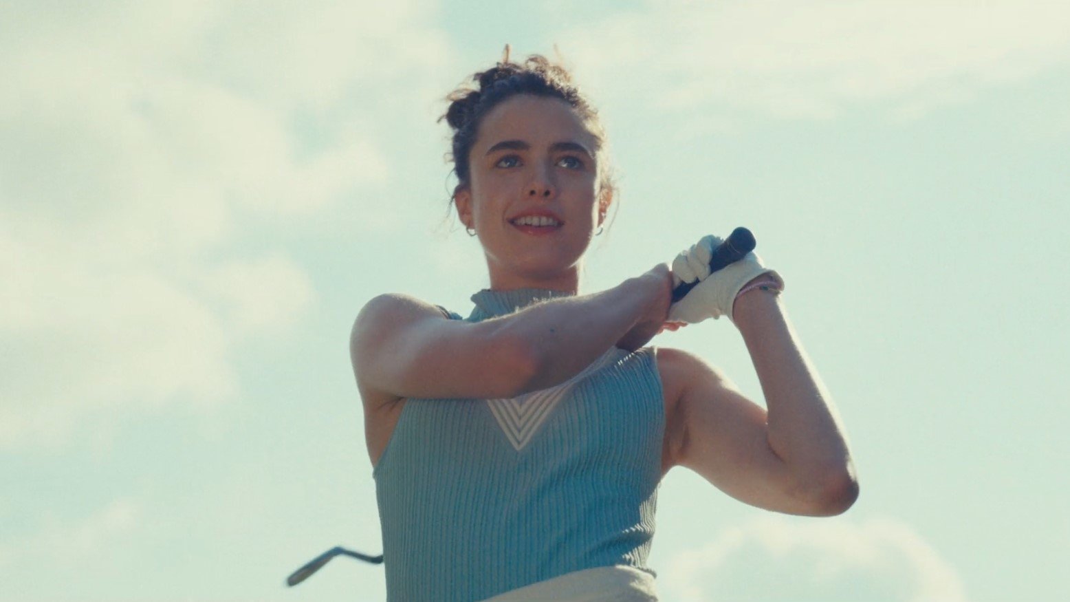 Caption: a woman holding a tennis racquet on top of a tennis court