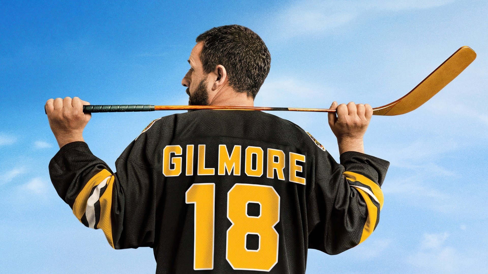 Caption: a man holding a hockey stick over his shoulder