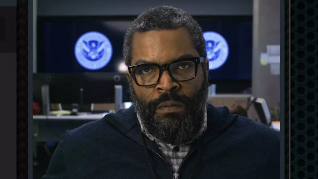 Caption: a man with a beard and glasses is looking at the camera