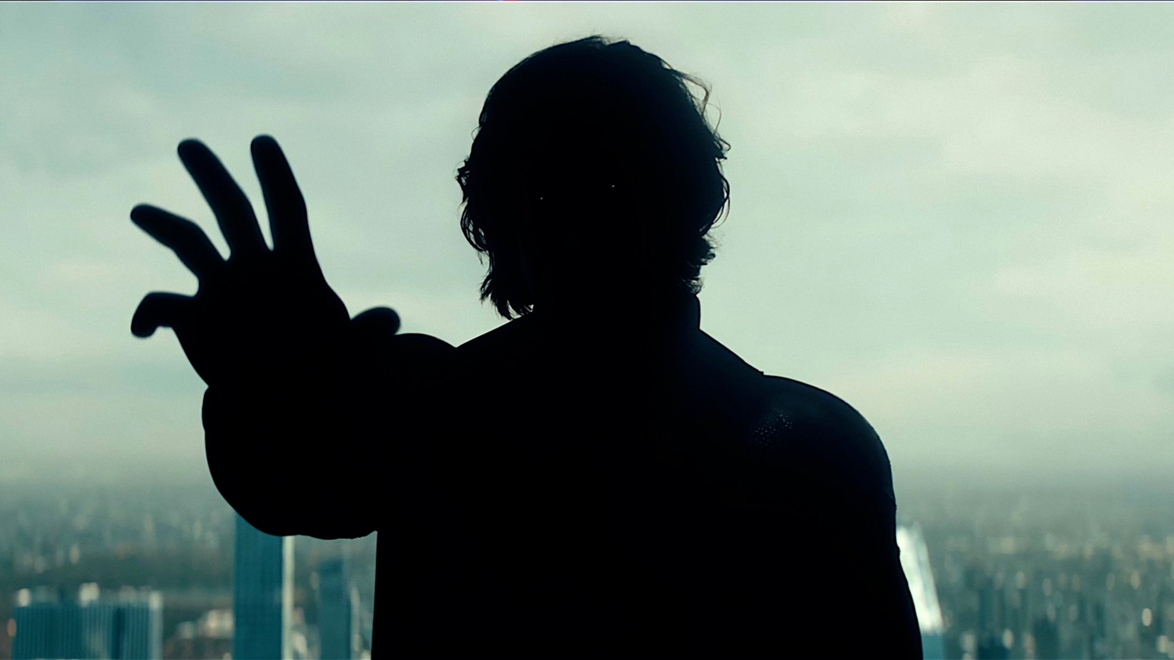 Caption: a silhouette of a man making a peace sign