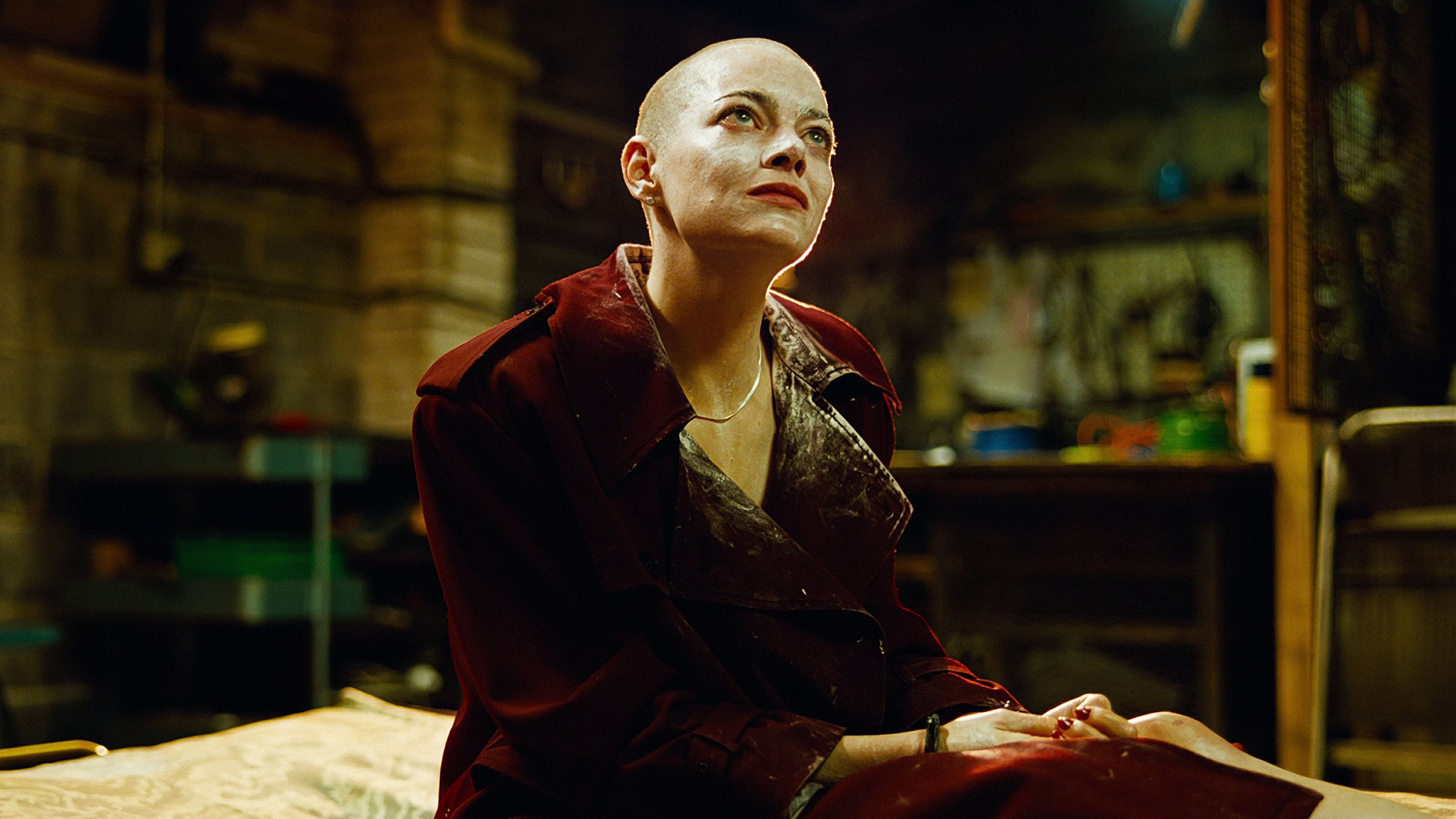 Caption: a woman sitting on top of a bed in a room