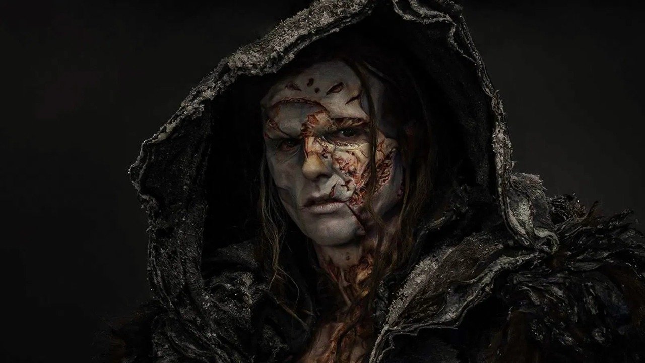 Caption: a man in a hooded jacket with blood on his face