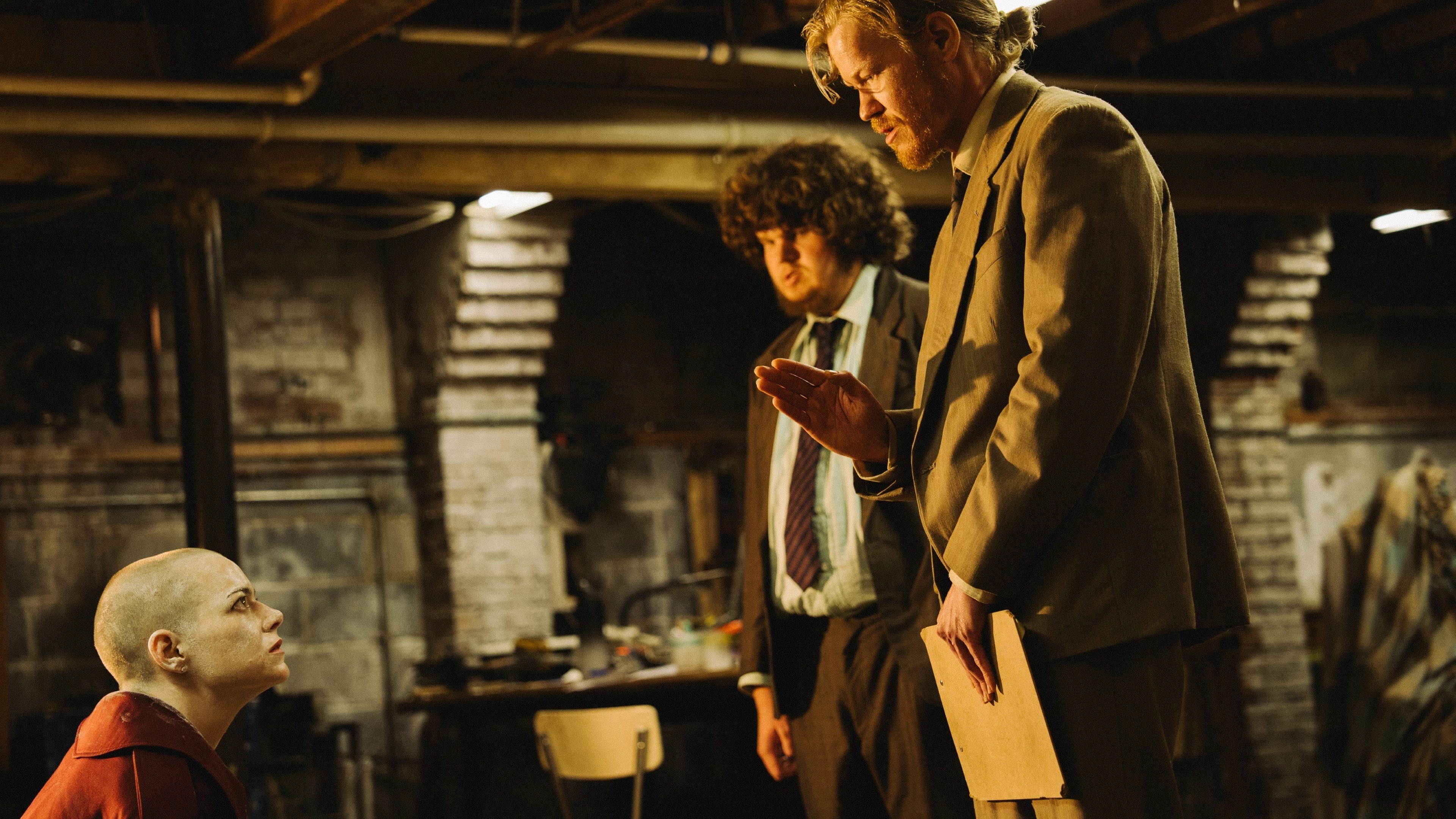 Caption: a man standing next to a little boy in a room