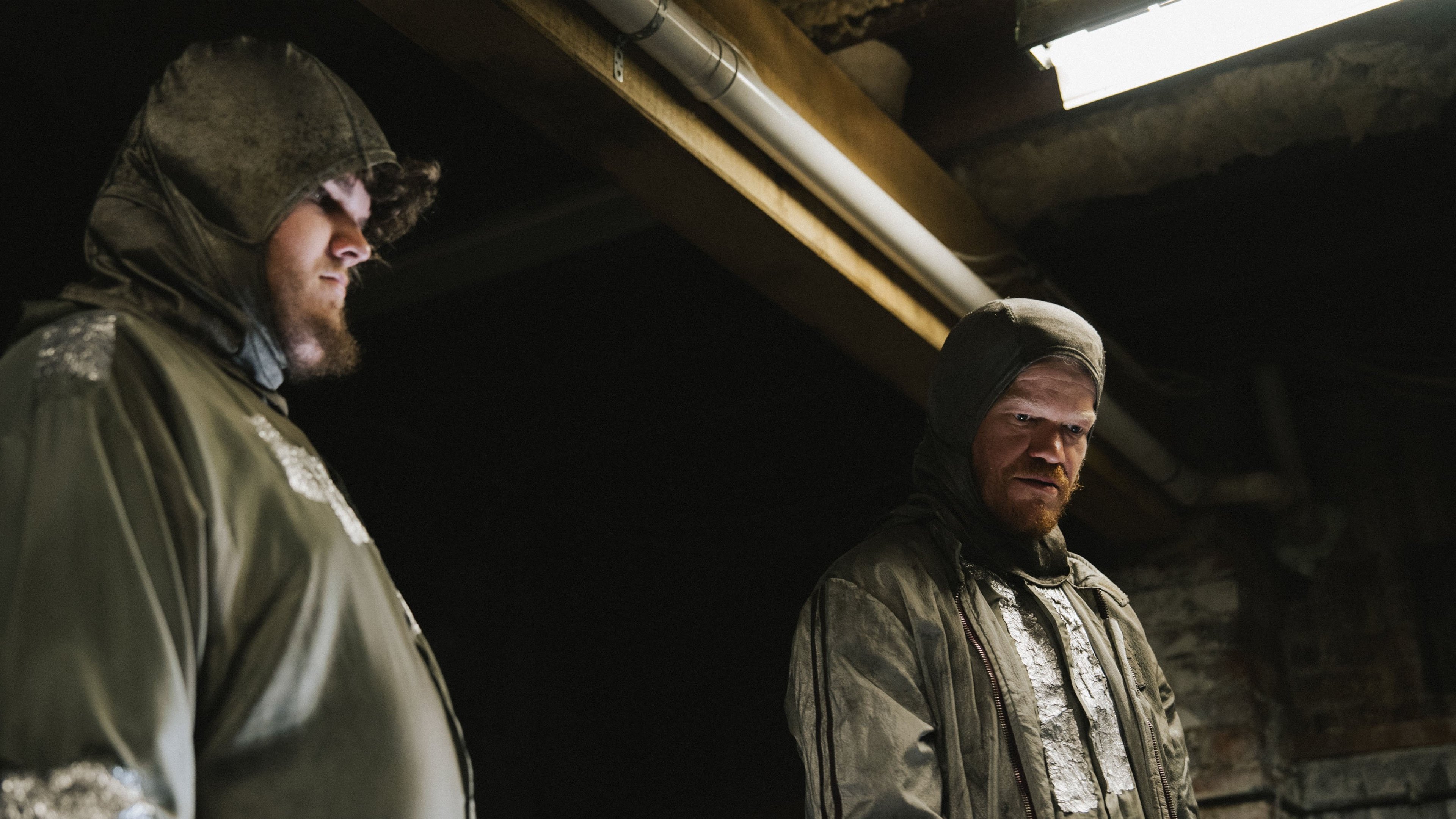 Caption: a couple of men standing next to each other