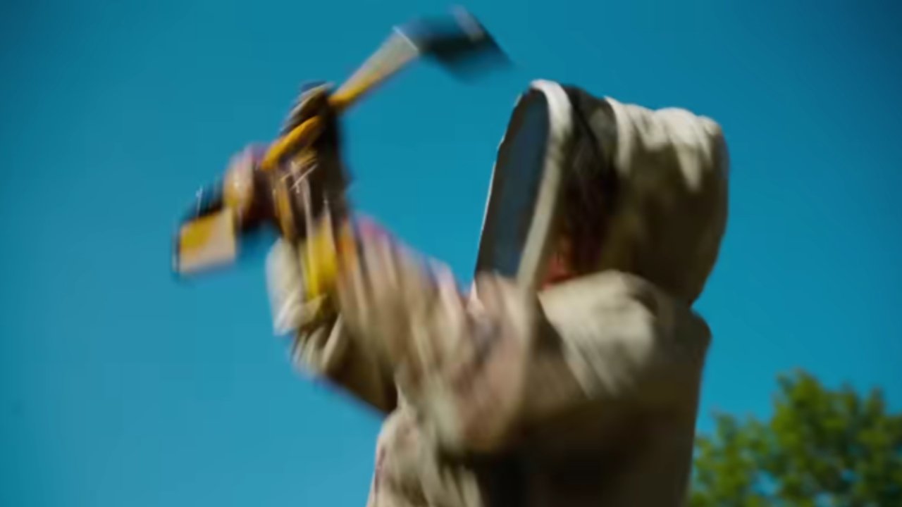 Caption: a blurry image of a man swinging a baseball bat