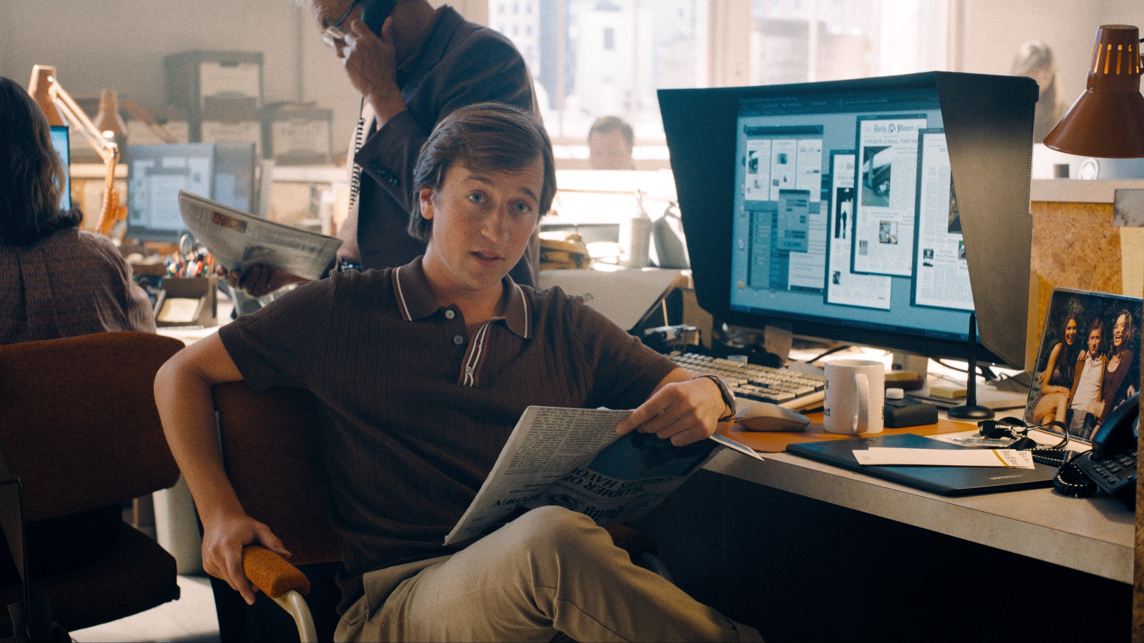 Caption: a man sitting in a chair in front of a computer