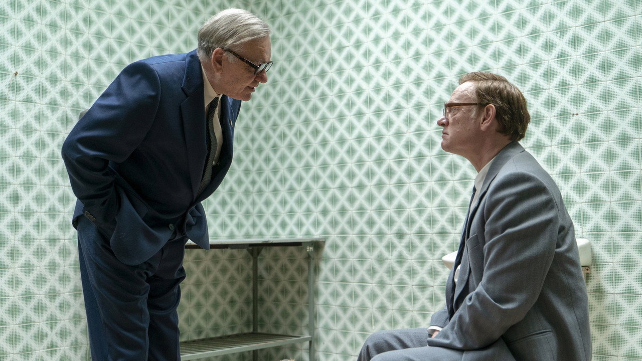 Two men speaking in a patterned room, Chernobyl (2019)