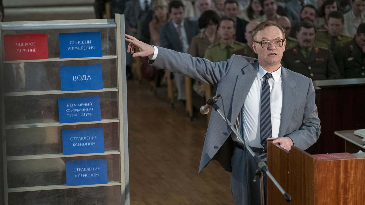 A man presenting colored cards before a courtroom, Chernobyl (2019)