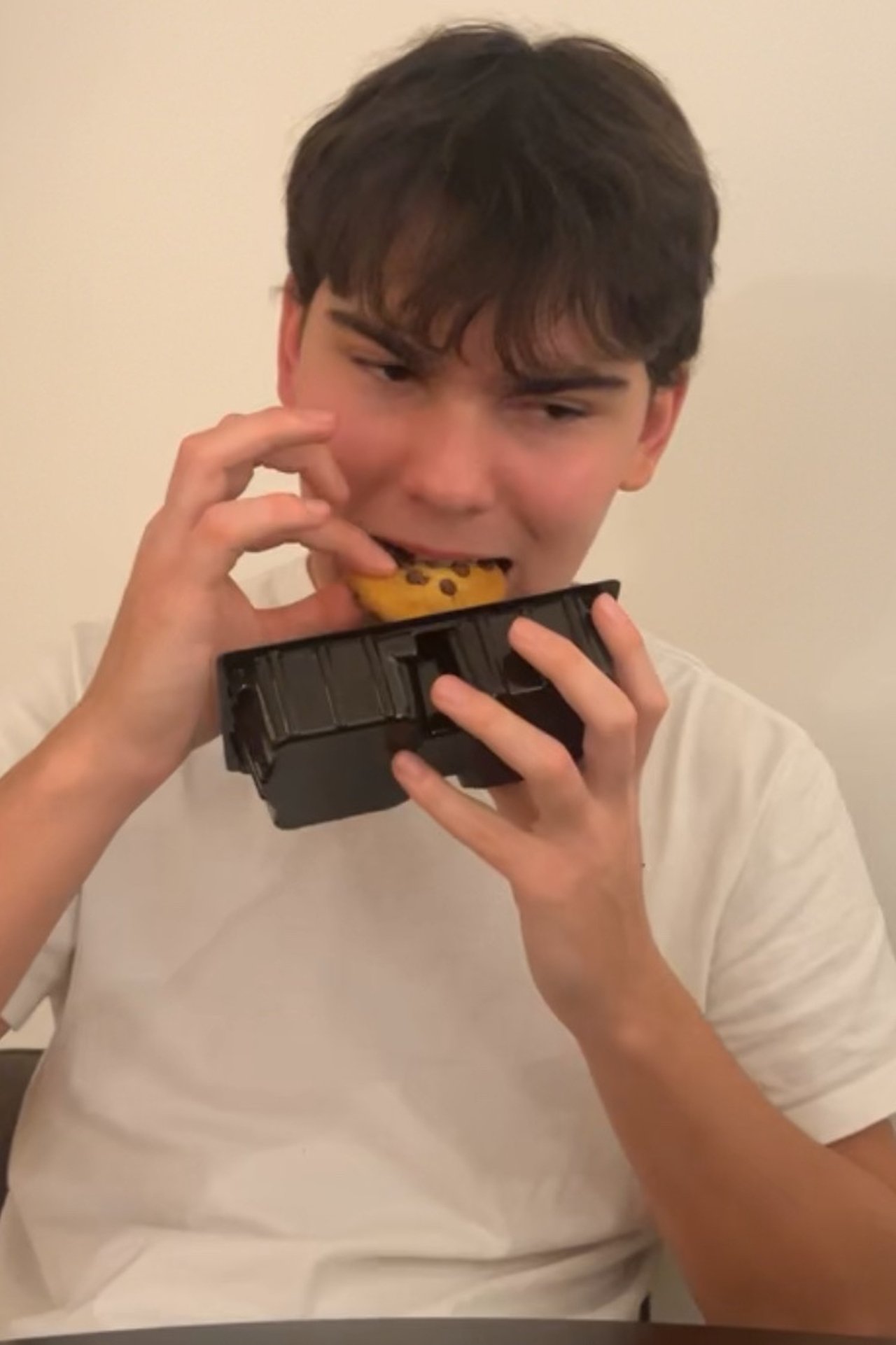 a chinese man eats a biscuit poster